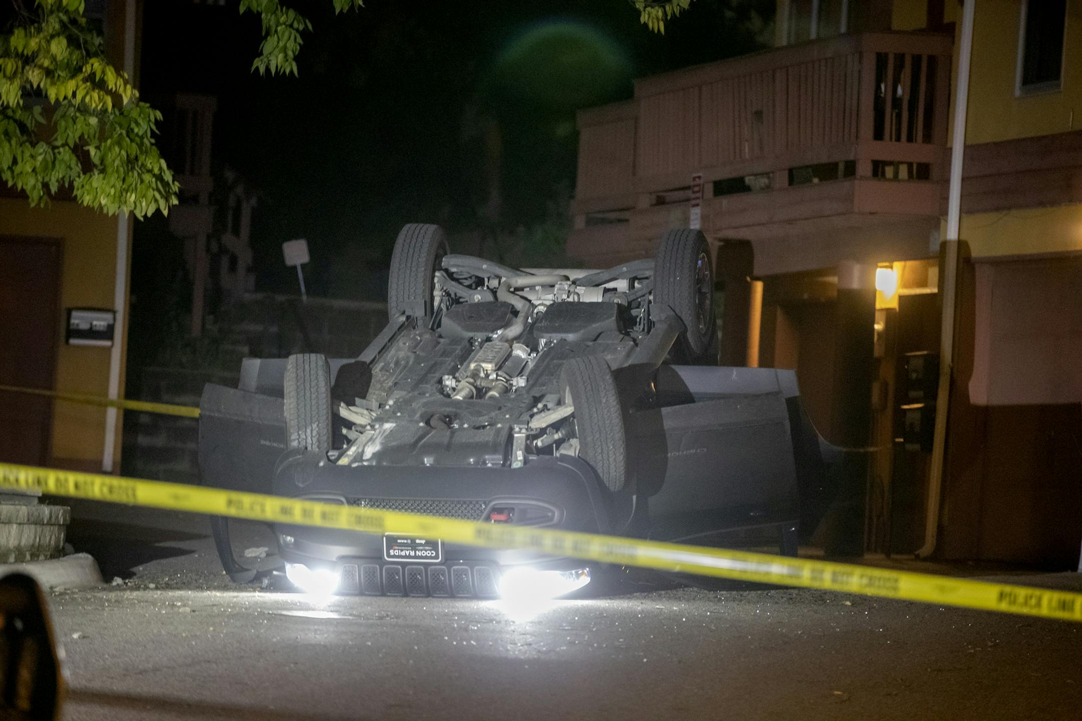 Police investigated the scene where one person and a child were found with gunshot wounds after a vehicle rollover on Sunday in St. Paul.