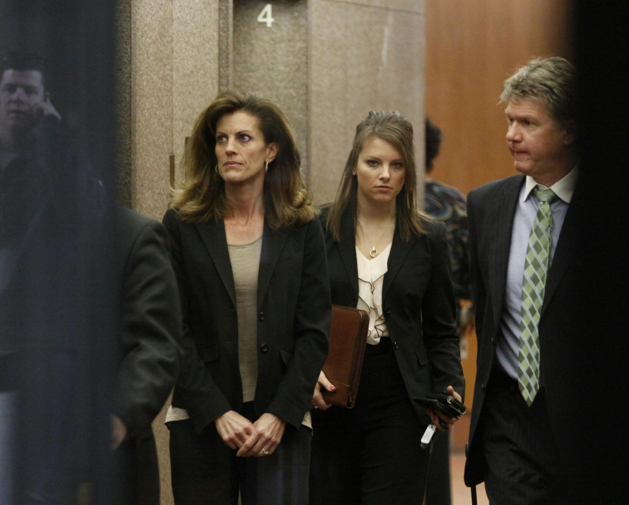 Amy Senser, at left, waits for an elevator at the Hennepin County Government Center for a court appearance Friday, March 9, 2012.