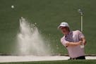 Tom Hoge hits out of a bunker on the second hole during a practice round at Augusta National Golf Club on Monday. 