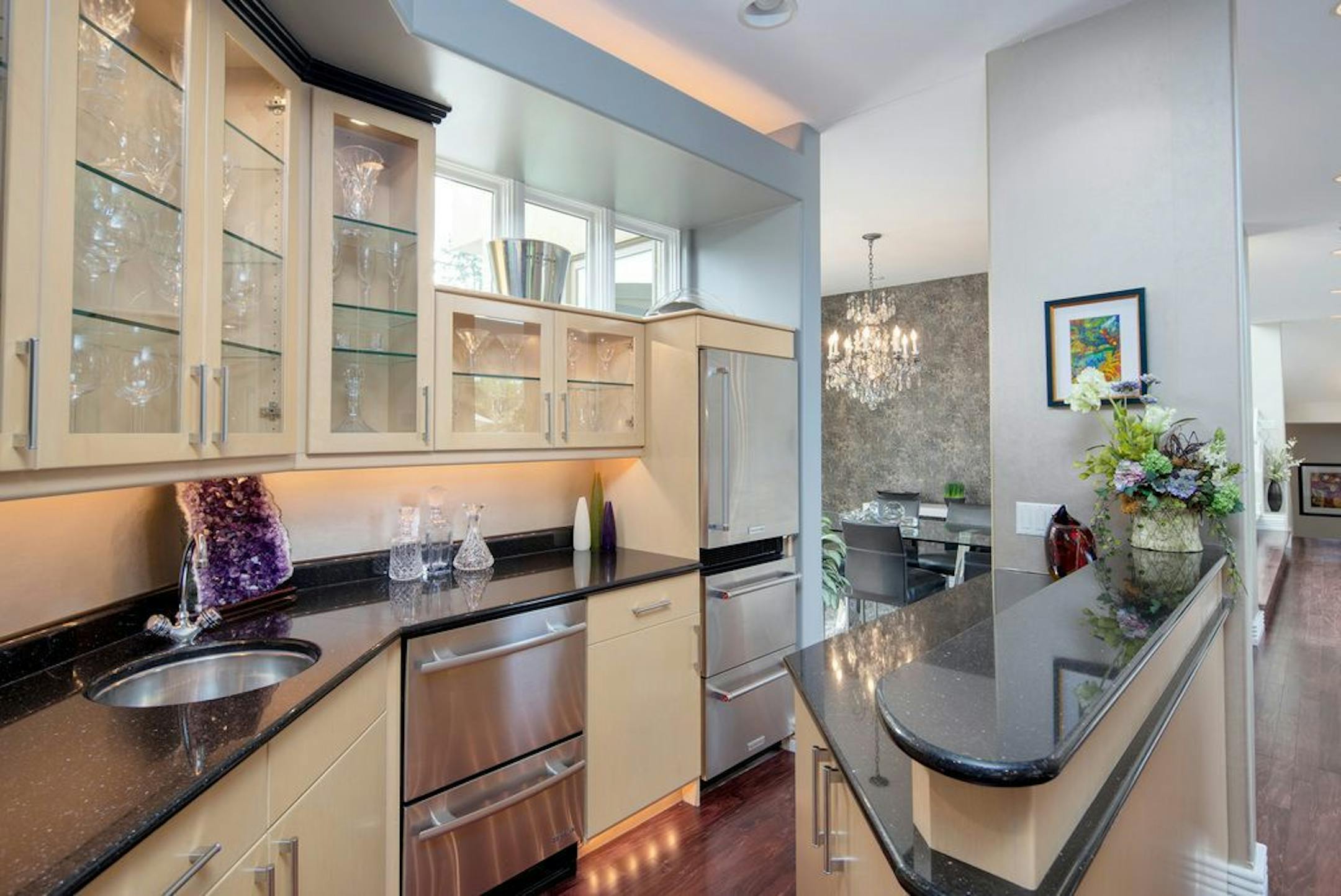 A bar is adjacent to the kitchen.