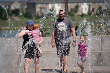 Christian Malone and his wife, Michelle, of Coon Rapids played with their kids Beverly, 4, and Juniper, 2 at Central Park in Maple Grove.