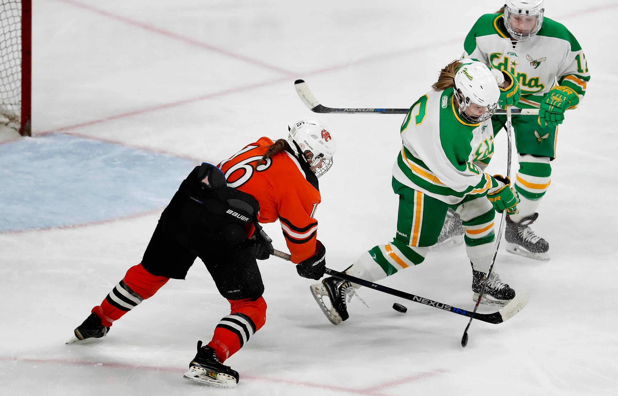 Ellie Moser (16) shot the puck past two Edina defenders to score a shorthanded goal in last year's Class 2A girls' hockey tournament.