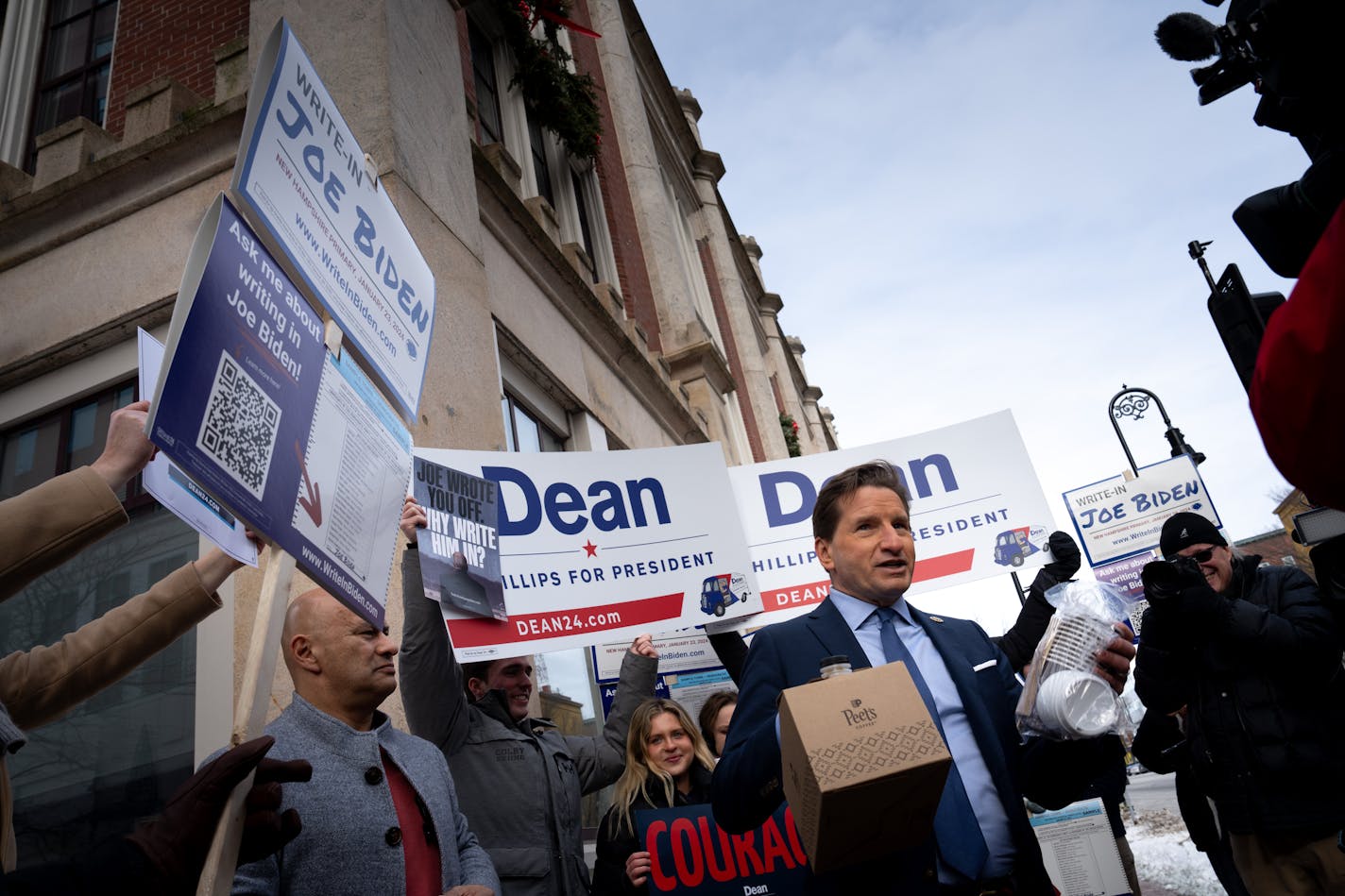 When a crowd rallied outside Dean Phillips New Hampshire campaign headquarters urging people to write in Joe Biden, Phillips responded by crossing the street and offering them hot coffee.  Saturday, Jan. 20, 2024  Manchester, New Hampshire.    ] GLEN STUBBE • glen.stubbe@startribune.com