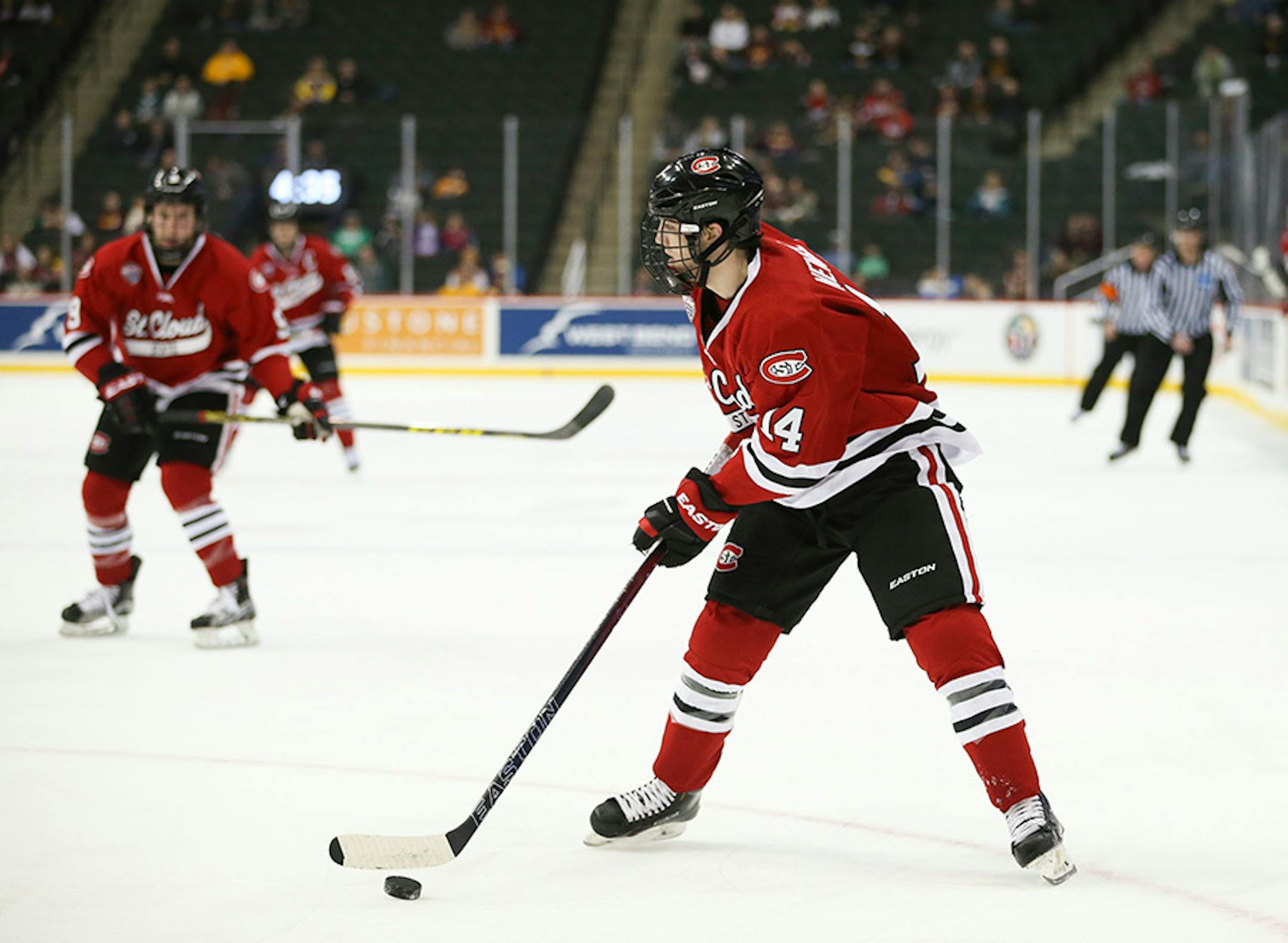 The Huskies' Patrick Newell (14) prepared to pass to Joey Benik (9), rear, who then scored his second goal of the first period Sunday afternoon.