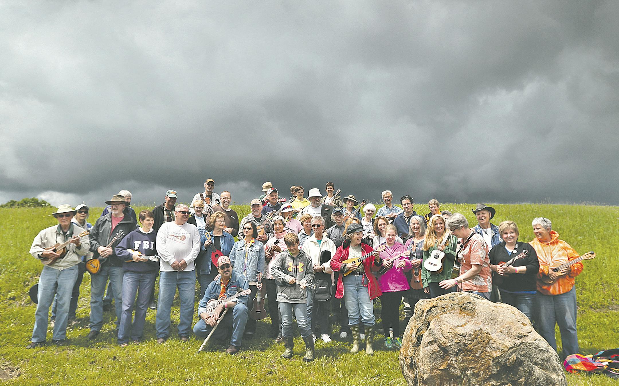 Uke afficionados posed under ominous skies at the Great Minnesota Ukulele Gathering at El Rancho Manana Campground outside St. Cloud.