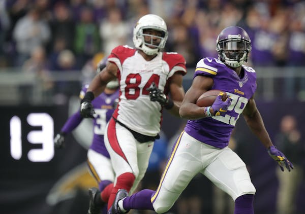 Vikings Xavier Rhodes runs past Cardinals Jermaine Gresham after intercepting a Carson Palmers pass and running it back 100 yards for the TD in the 2n