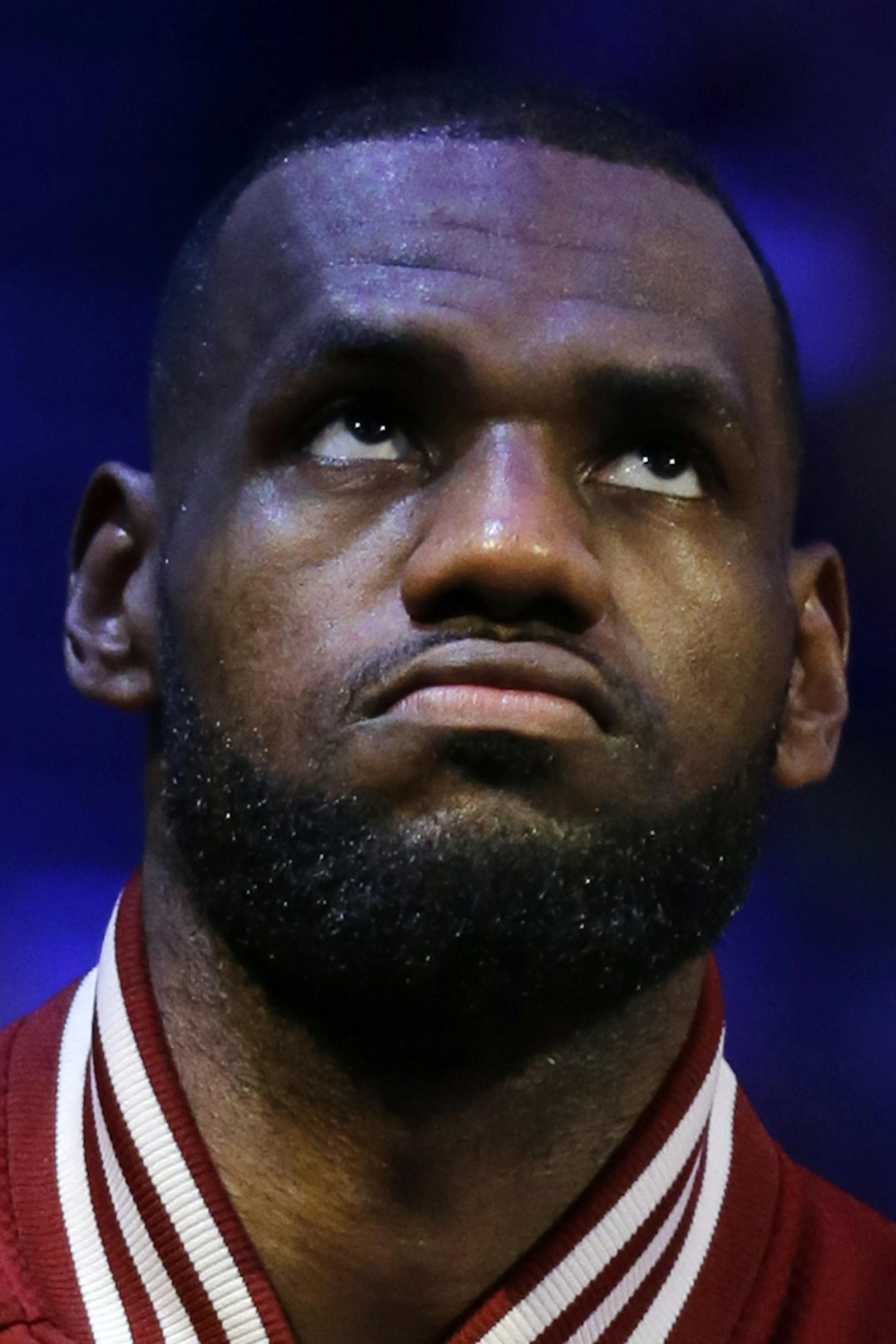 Cleveland Cavaliers forward LeBron James listens to the nation anthem before Game 3 of basketball's NBA Finals against the Golden State Warriors in Cleveland, Tuesday, June 9, 2015. (AP Photo/Tony Dejak)