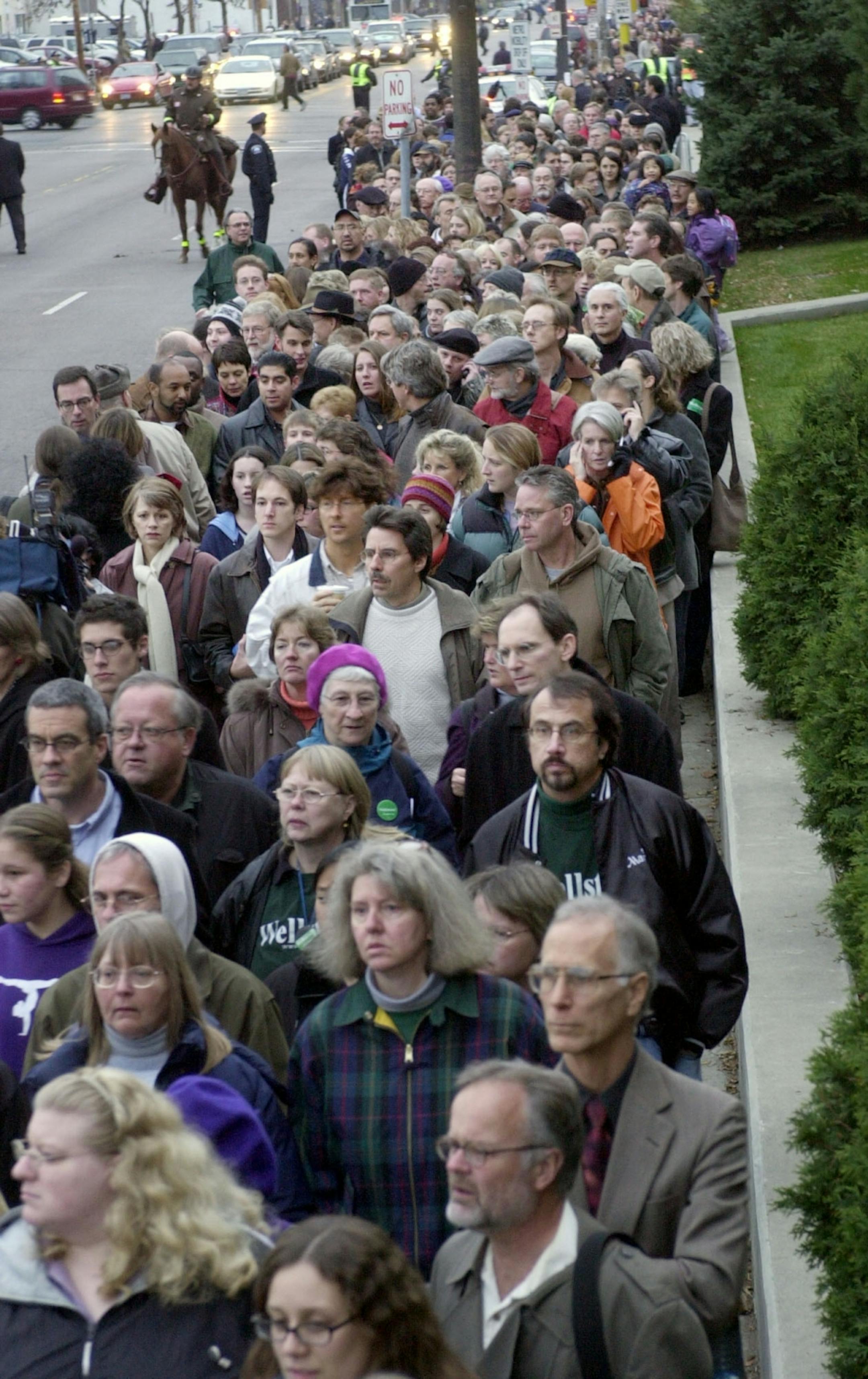 Thousands of mourners stand in line to attend a public memorial service, Tuesday, Oct. 29 2002, in Minneapolis, for U.S. Sen. Paul Wellstone, his wife, daughter and three staff members who died Friday, Oct. 25, 2002, in a plane crash in Eveleth, Minn.