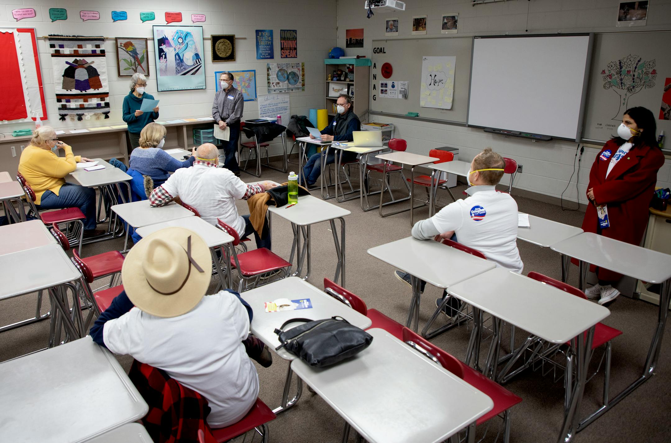 Residents listen to the agenda during a DFL caucus Tuesday, Feb. 1, at North High School in North Saint Paul, Minn. ] CARLOS GONZALEZ • cgonzalez@startribune.com