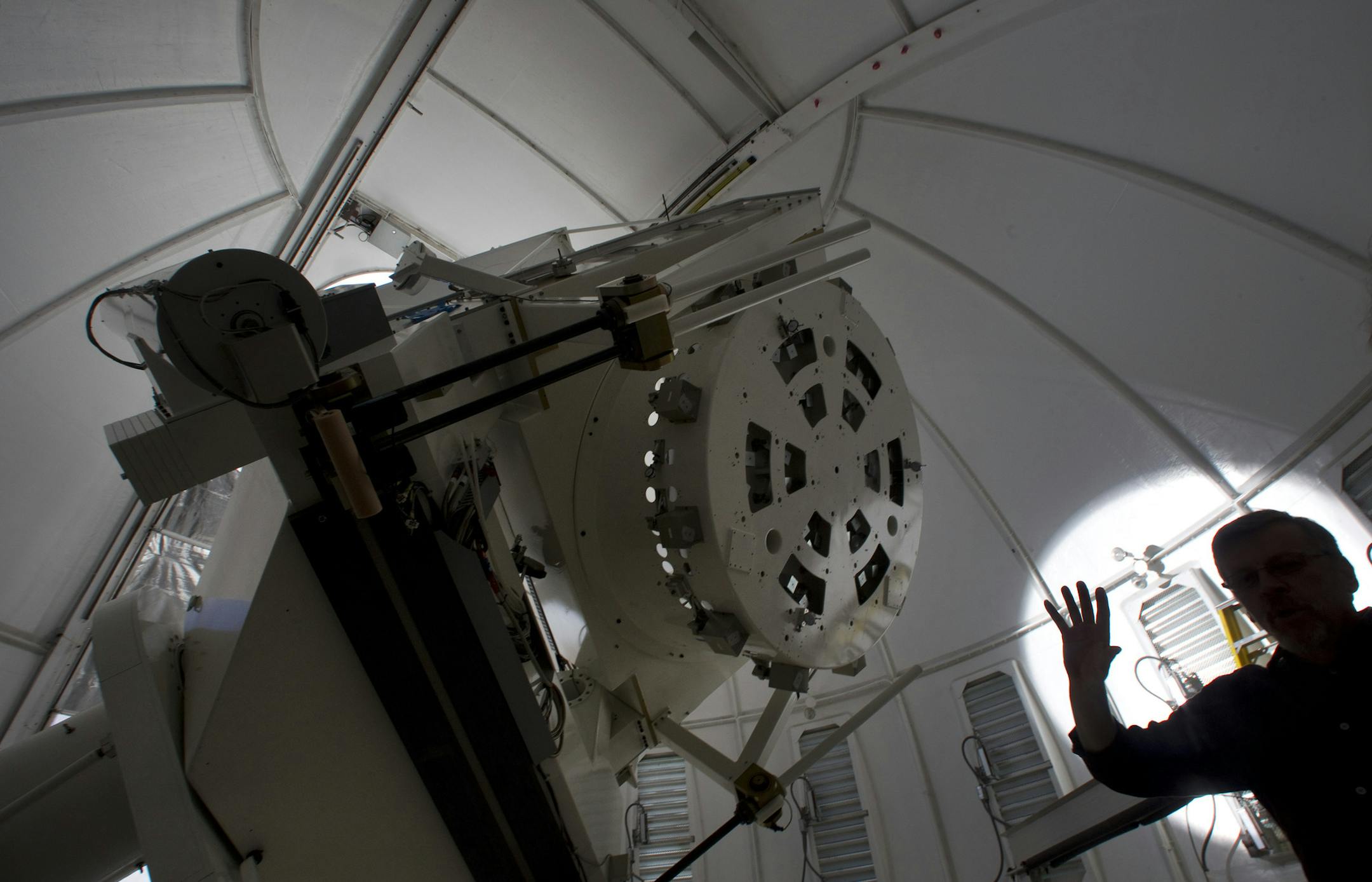 Vasyl Yurchyshyn, research professor at the Big Bear Solar Observatory, is silhouetted by the sun next to the 1.6-meter telescope at the Big Bear Observatory on October 7, 2014, at the end of a jetty on California's Big Bear Lake. (Allen J. Schaben/Los Angeles Times/TNS) ORG XMIT: 1161923 ORG XMIT: MIN1412302312372835