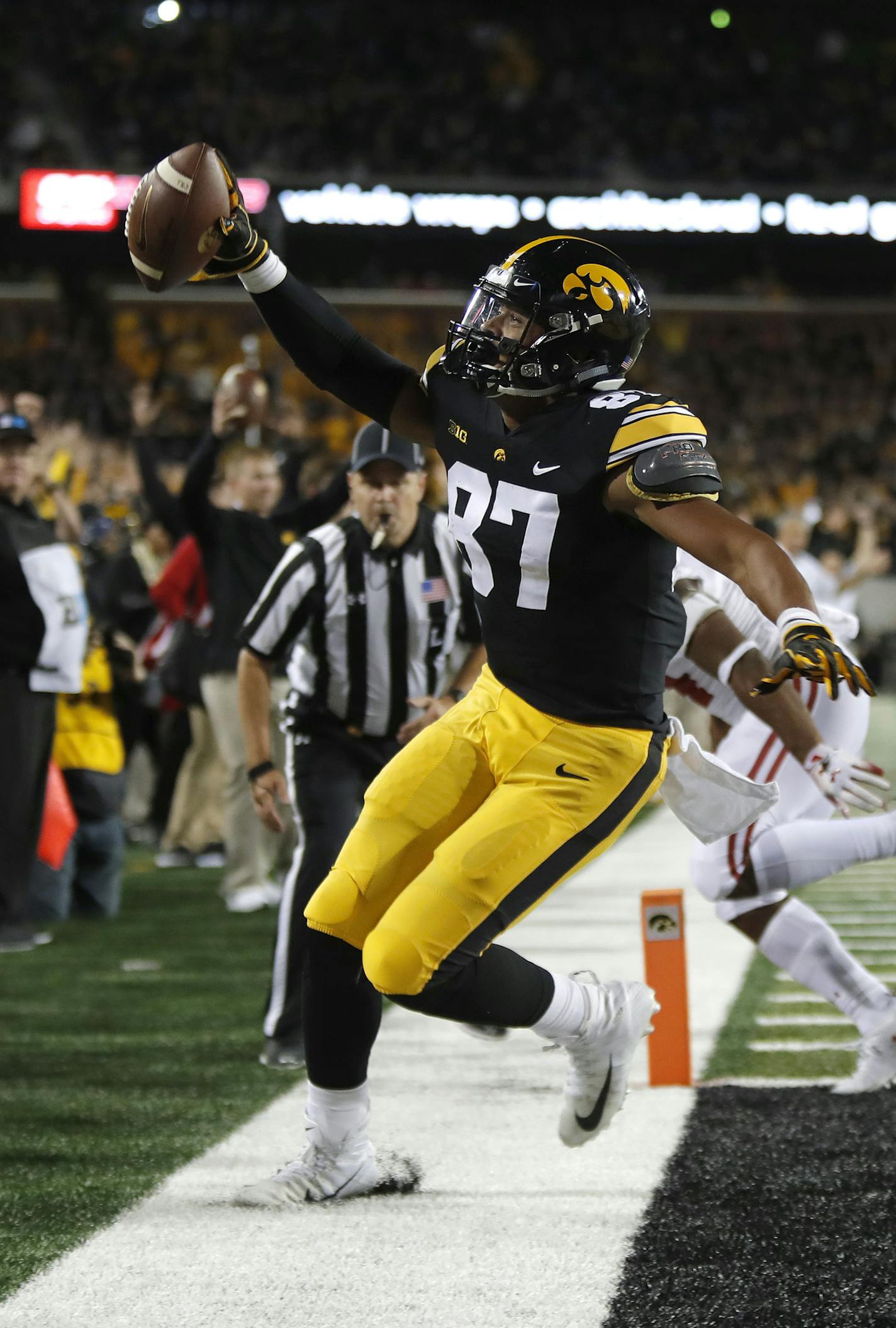 Iowa tight end Noah Fant runs in a touchdown and points to the crowd during the second half of an NCAA college football game against Wisconsin, Saturday, Sept. 22, 2018, in Iowa City. (AP Photo/Matthew Putney)