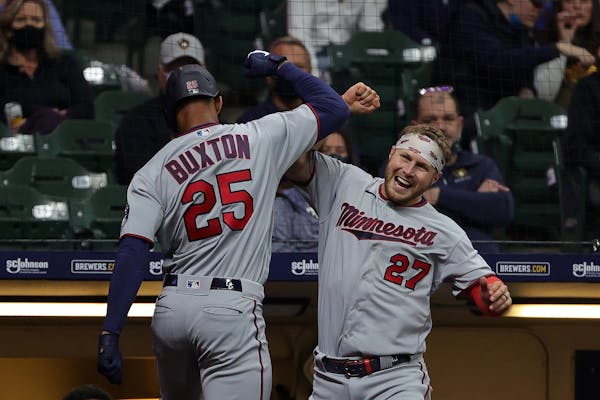The Minnesota Twins' Byron Buxton (25) celebrates a solo home run with teammate Ryan Jeffers during the seventh inning against the Milwaukee Brewers a