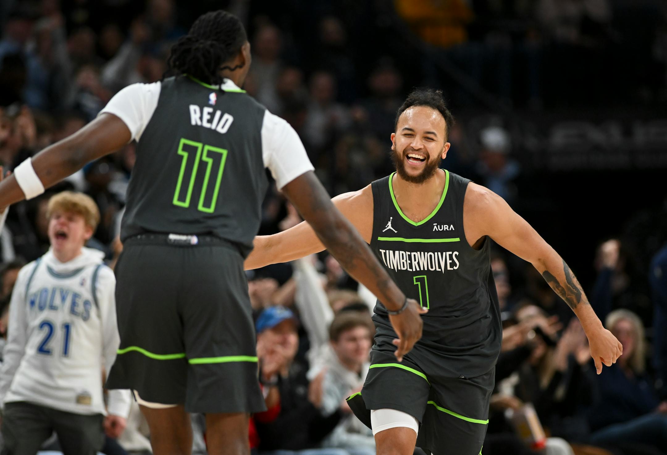 Minnesota Timberwolves forward Kyle Anderson (1) and center Naz Reid (11) celebrate a 3-pointer scored by Anderson in the second half against the Dallas Mavericks Thursday, Dec. 28, 2023 at Target Center in Minneapolis, Minn.. ] AARON LAVINSKY • aaron.lavinsky@startribune.com