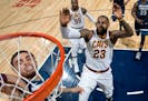 Wolves point guard Tyus Jones dunked the ball while being chased by the Cavaliers' LeBron James on Jan. 8.