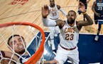 Wolves point guard Tyus Jones dunked the ball while being chased by the Cavaliers' LeBron James on Jan. 8.