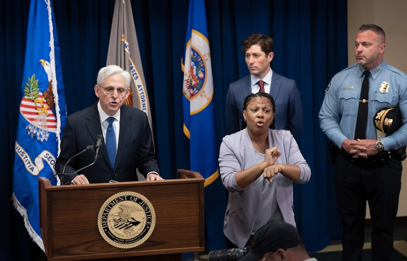 U.S. Attorney General Merrick Garland, with Mayor Jacob Frey and Police Chief Brian O'Hara at a news conference.