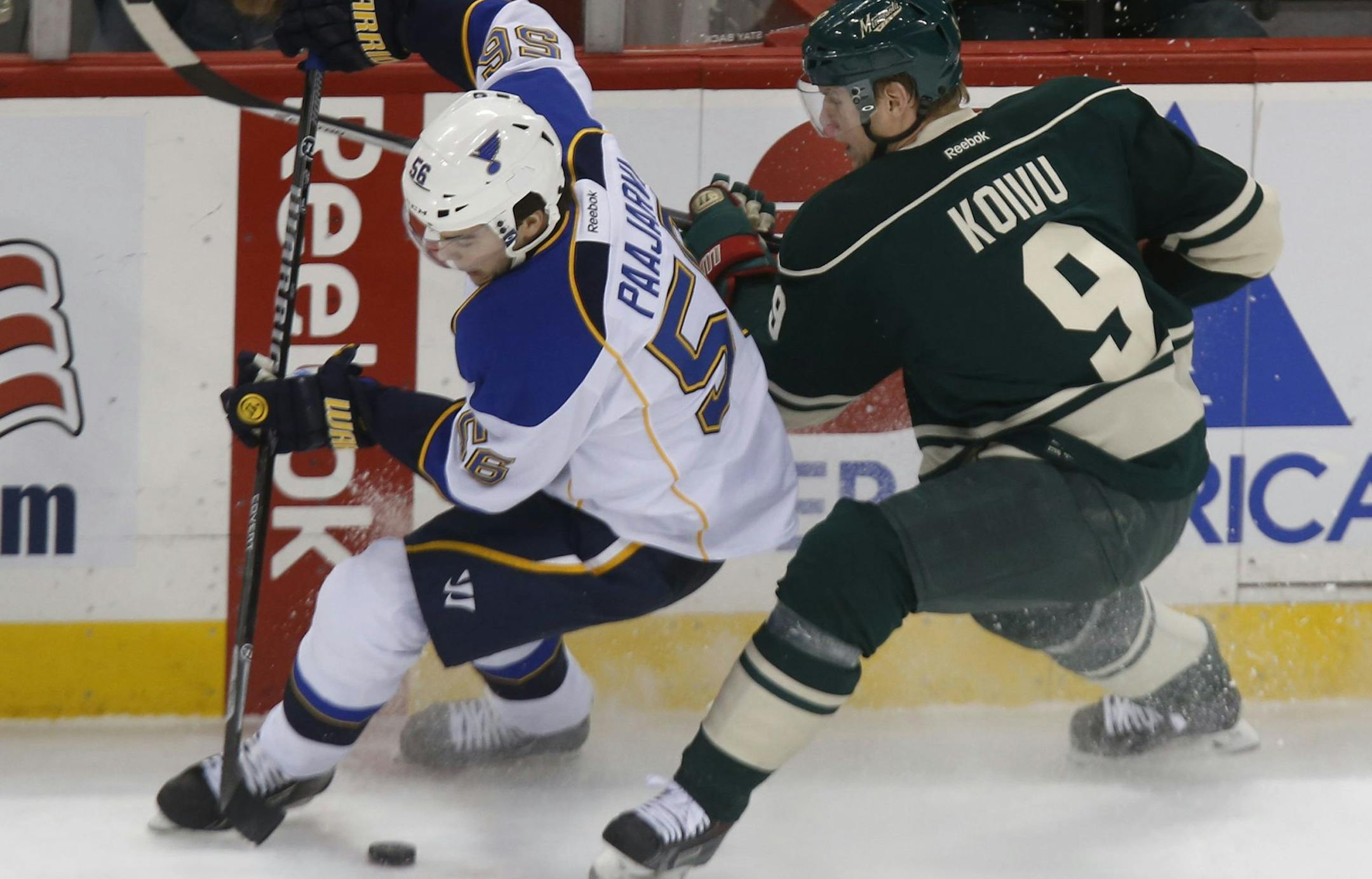 St. Louis Blues' Magnus Paajarvi (56) and Minnesota Wild's Mikko Koivu (9) battle for the puck at the Xcel Energy Center in St. Paul, Minn., on Tuesday, Dec. 31, 2013. (Richard Tsong-Taatari/Minneapolis Star Tribune/MCT) ORG XMIT: 1147376