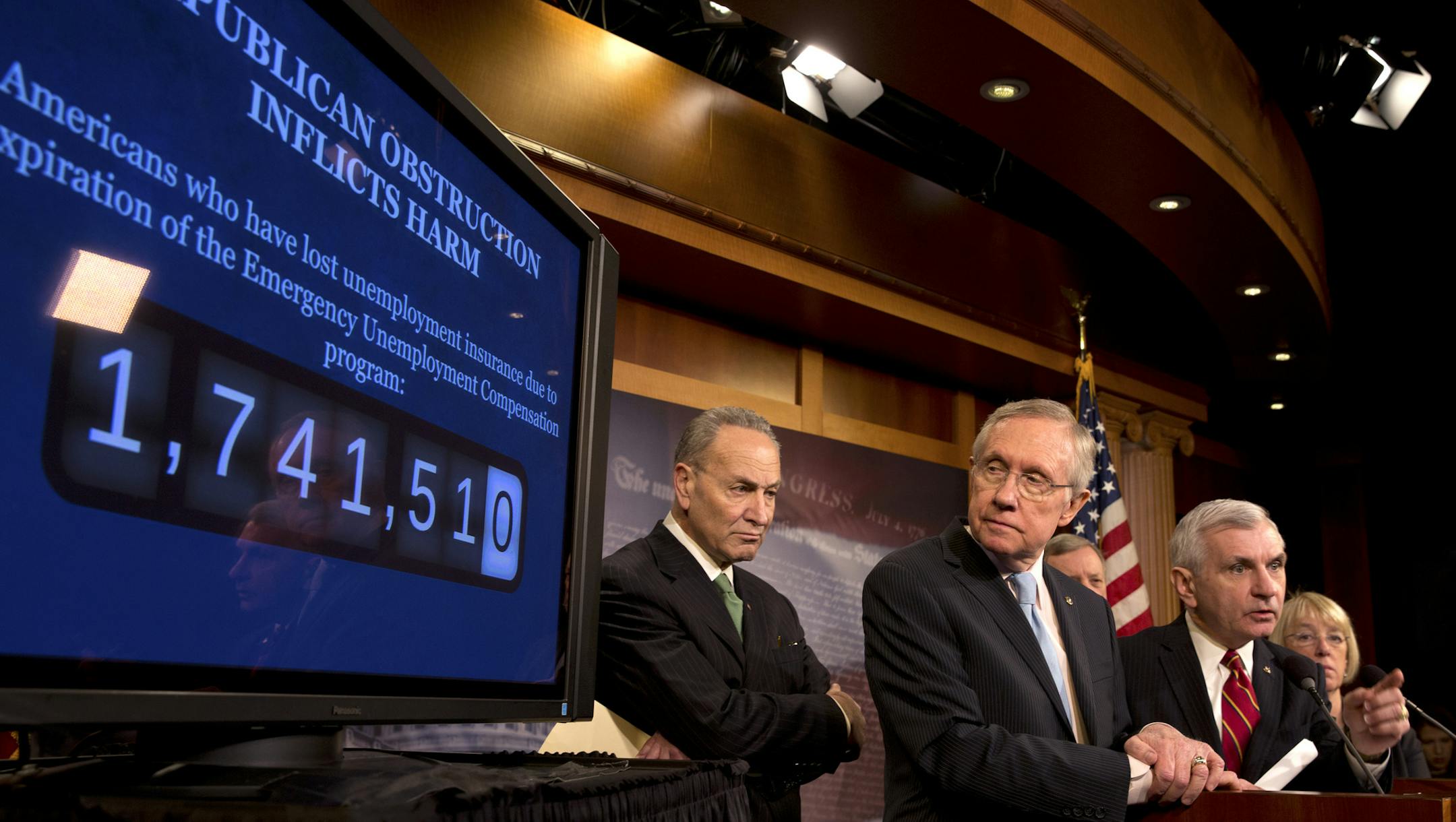 Senate Majority Leader Harry Reid (D-Nev.) looks at a count of Americans affected by the loss of long-term unemployment benefits, on Capitol Hill in Washington, Feb. 6, 2014. The Senate held a vote on a three-month extension of benefits but the 55-42 vote fell five short of breaking the threat of a Republican filibuster. From left: Sens. Chuck Schumer (D-N.Y.), Reid, Jack Reed (D-R.I.) and Patty Murray (D-Wash.) (Stephen Crowley/The New York Times)