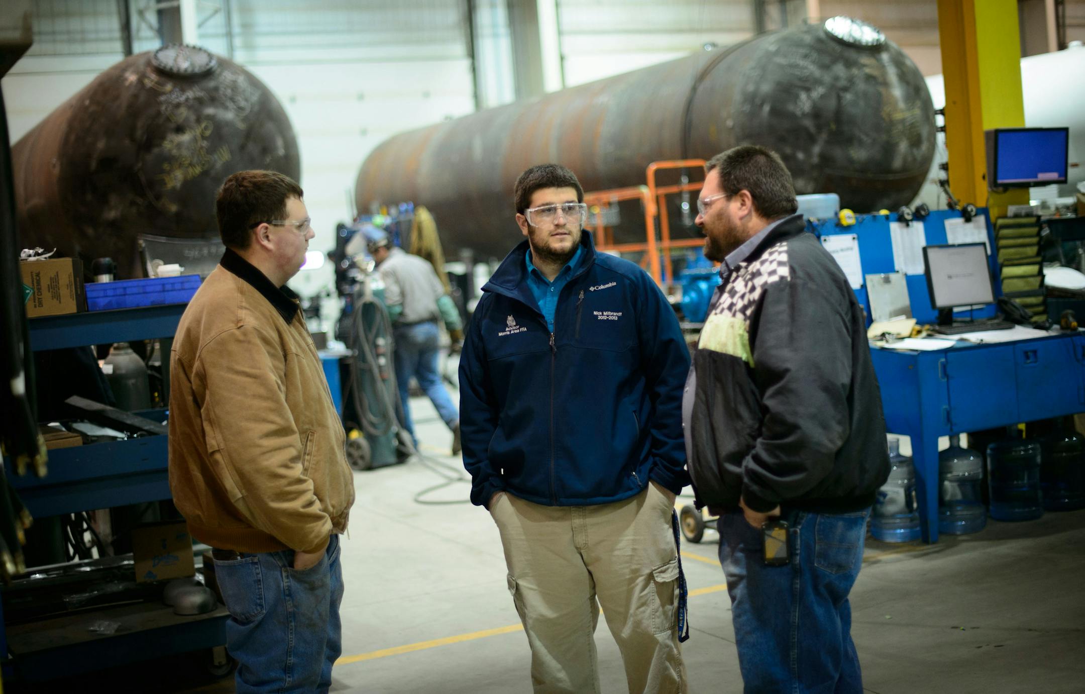 Nick Milbrandt, center, new agriculture educator at Morris Area High School paid a surprise visit to student Timothy Uphoff, left, who is doing job training at Westmor Industries in Morris. Timothy’s supervisor, warehouse manager John Manska is on the right.