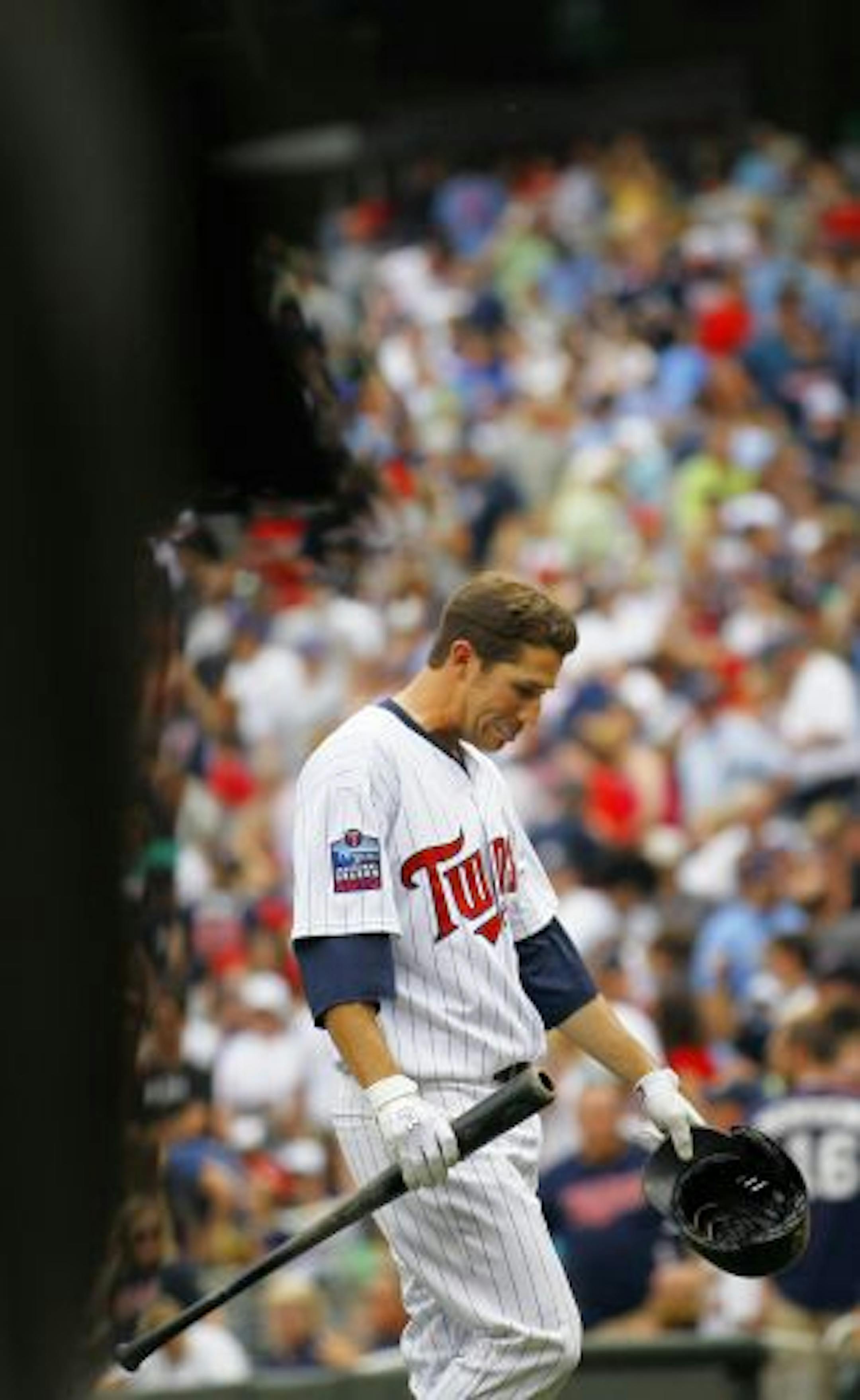Trevor Plouffe walks off the field after striking out with bases loaded in the bottom of the 9th inning. Twins lose to the Brewers 4 to 3.