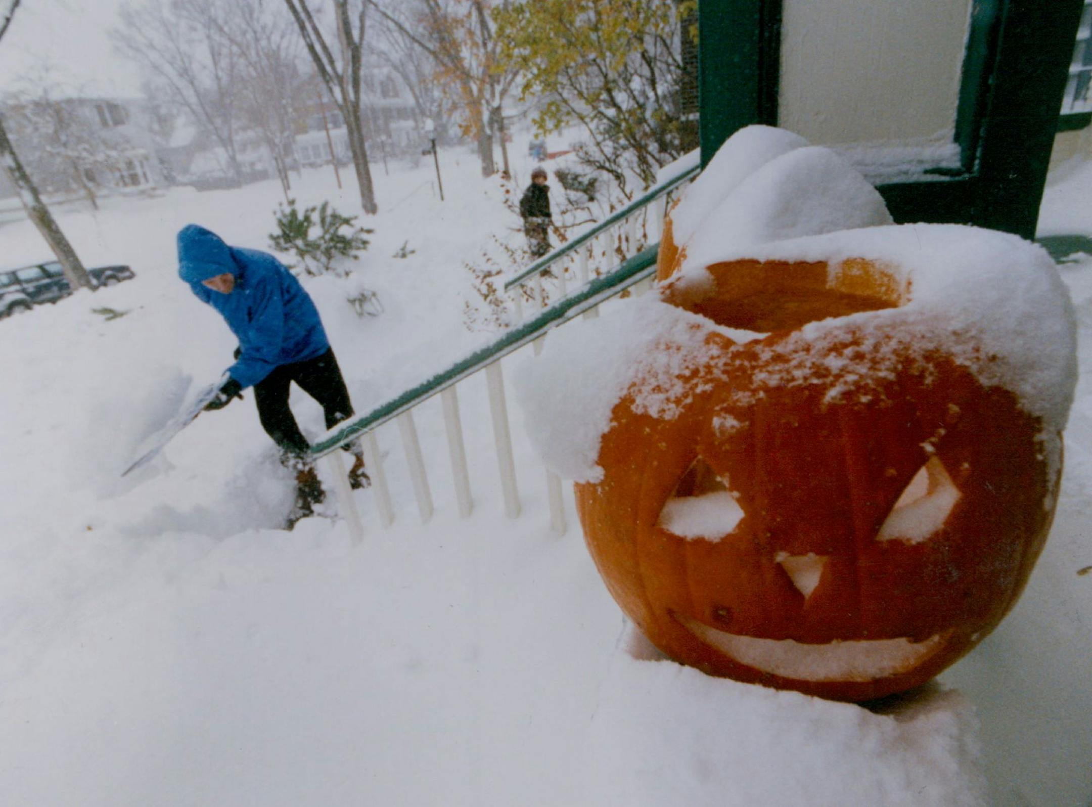 November 1, 1991 Halloween Blizzard feature photos. John Floberg shovels out his walk on James Ave. S. Mpls with a jack o latern a mute witness to the snow. November 3, 1991 Rick Sennott, Minneapolis Star Tribune