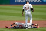 Pirates lefthander Martín Pérez (54) checks on Braves star Ronald Acuña Jr. after he injured himself running the bases during the first inning in P