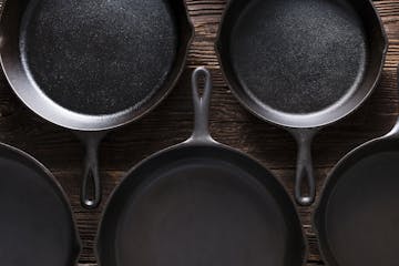 Cast Iron Skillets pans on Rustic Wood Table