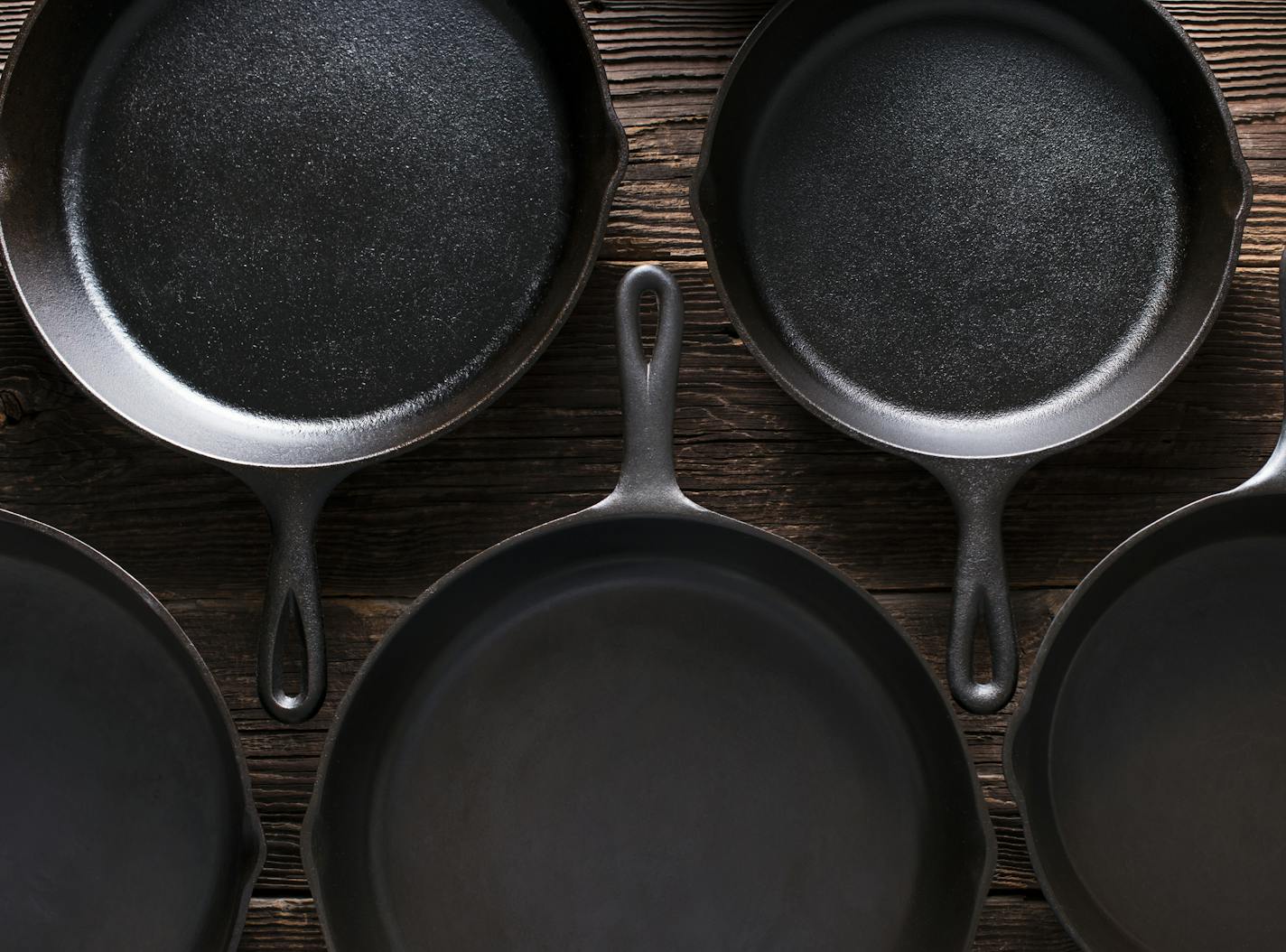 Cast Iron Skillets pans on Rustic Wood Table