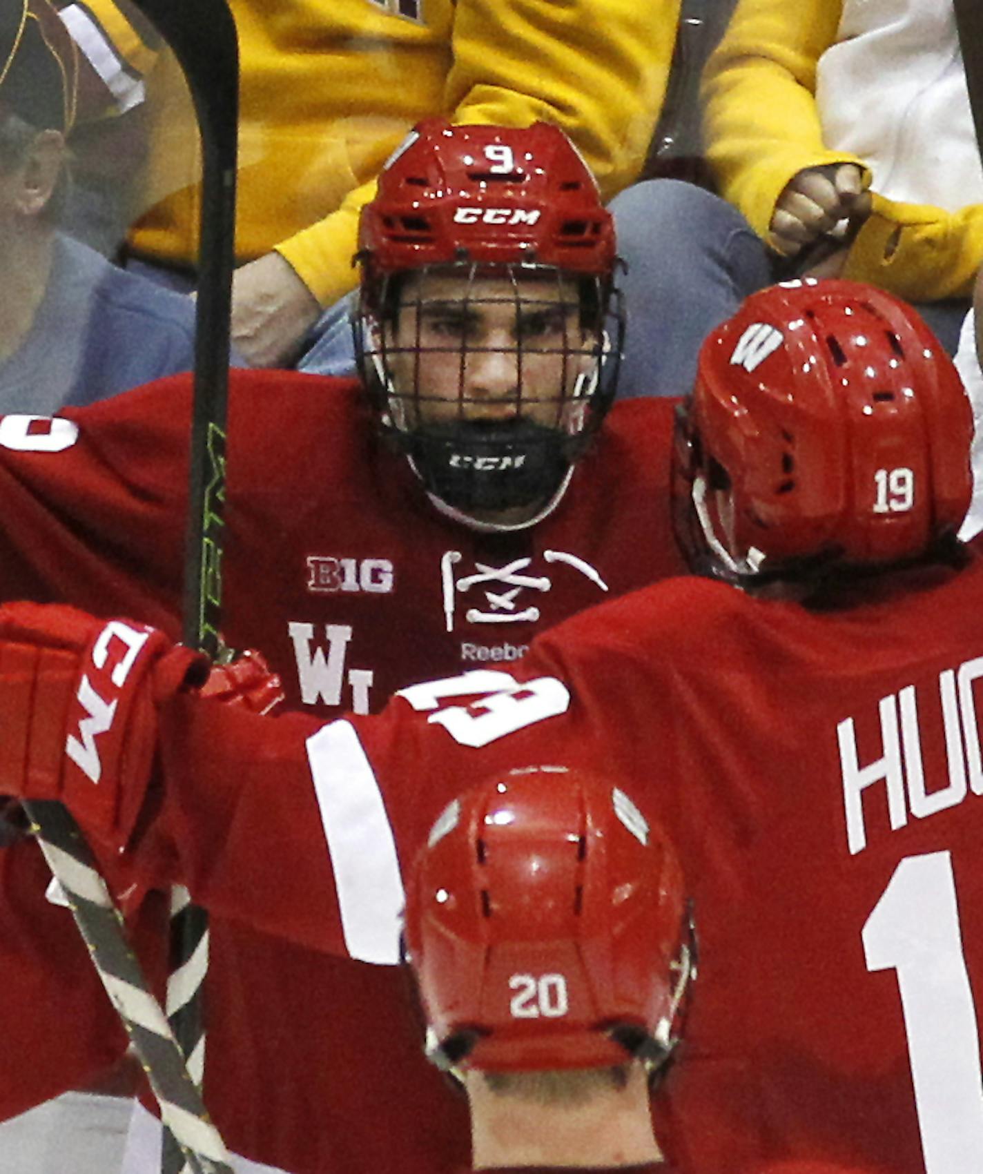 Wisconsin forward Luke Kunin (9) is congratulated by teammates Jake Linahrt and Cameron Hughes after scoring a goal against Minnesota in the first period of an NCAA college hockey game, Friday, March 11, 2016, in Minneapolis.(AP Photo/Andy Clayton-King) ORG XMIT: MNAK107