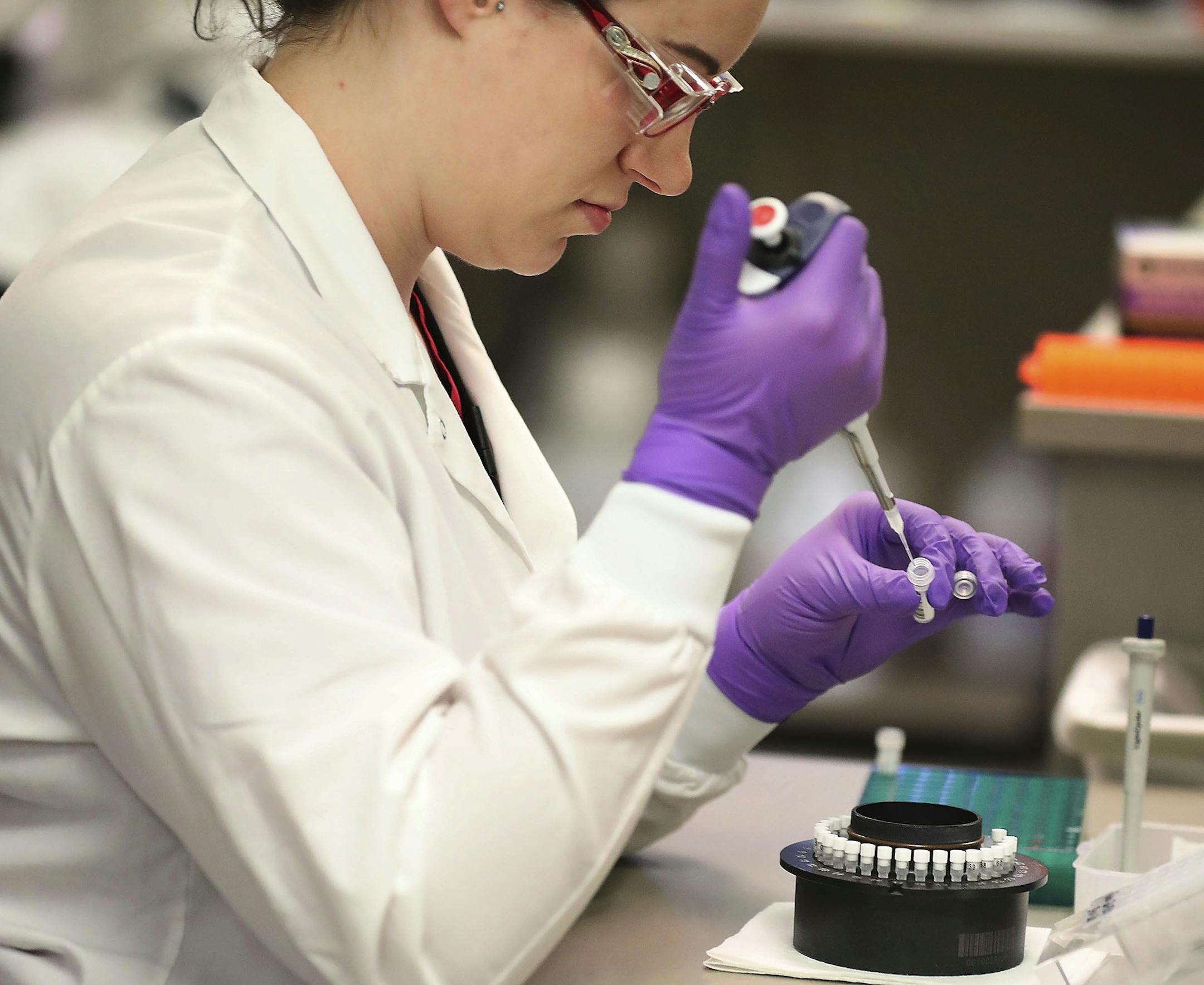 In this March 10, 2020, photo, Heather Peters, a lab technologist, works in the extracting of RNA from test samples in the Mayo virology lab at the Mayo Clinic Superior Drive facility in Rochester, Minn. Vice President Mike Pence has an appointment Tuesday at Minnesota&#x2019;s Mayo Clinic to learn about a new coronavirus testing &#x201c;moonshot&#x201d; that has the famed clinic partnering with the state and its flagship university to quickly boost the state's capacity to 20,000 tests a day. (D