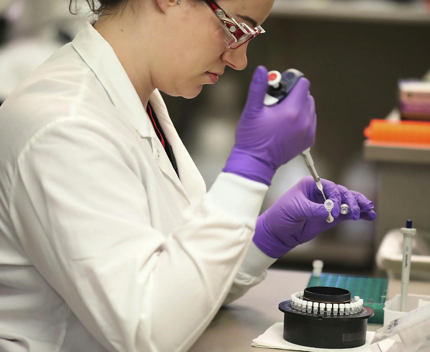 In this March 10, 2020, photo, Heather Peters, a lab technologist, works in the extracting of RNA from test samples in the Mayo virology lab at the Mayo Clinic Superior Drive facility in Rochester, Minn. Vice President Mike Pence has an appointment Tuesday at Minnesota&#x2019;s Mayo Clinic to learn about a new coronavirus testing &#x201c;moonshot&#x201d; that has the famed clinic partnering with the state and its flagship university to quickly boost the state's capacity to 20,000 tests a day. (D