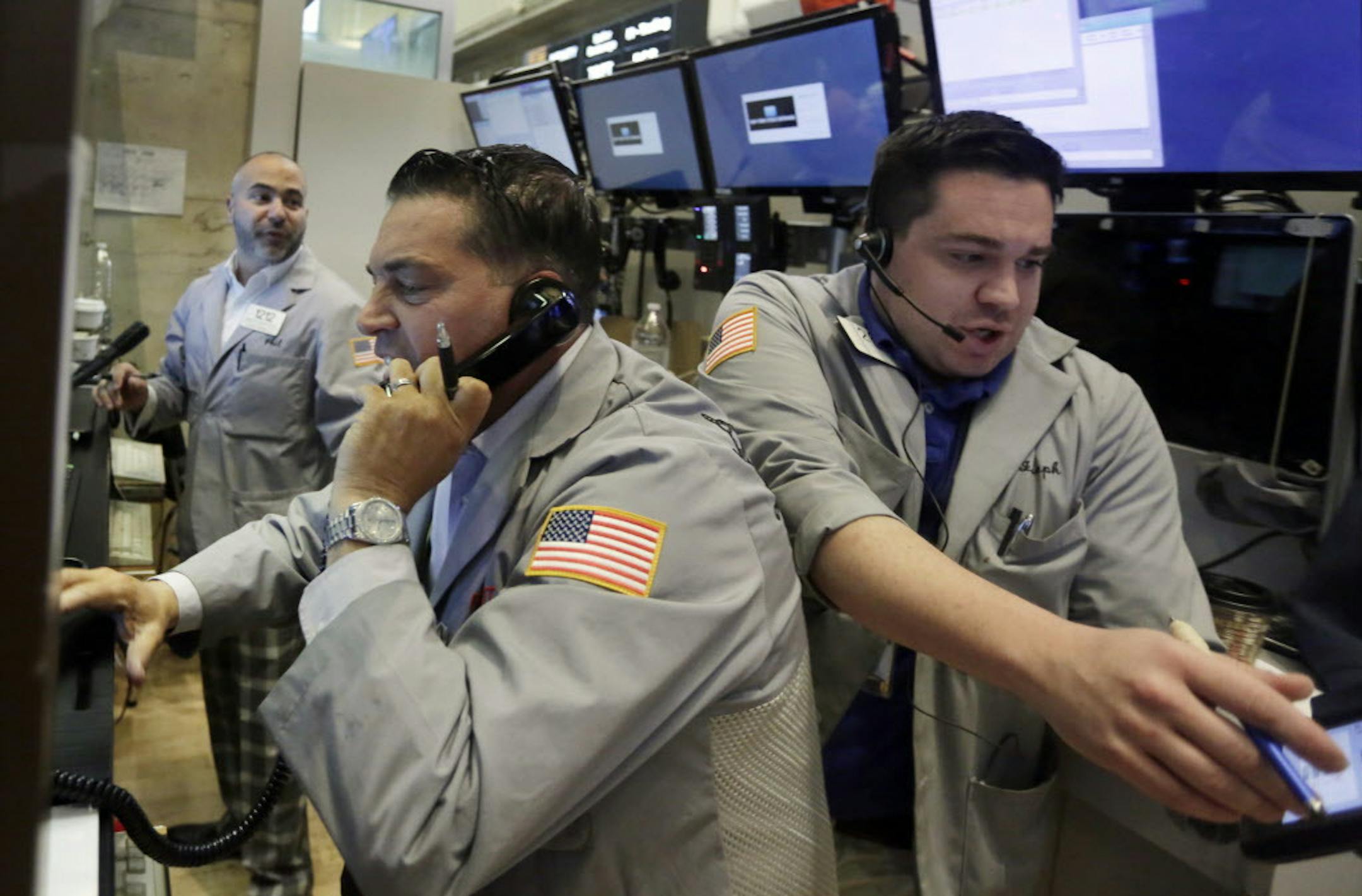 Traders Jonathan Mueller, center, and Joseph Lawler, right, work on the floor of the New York Stock Exchange, Friday, June 24, 2016. U.S. stocks are plunging in early trading after Britons voted to leave the European Union. (AP Photo/Richard Drew)