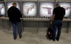 Patrons viewed handguns on display at a trade show in Las Vegas in 2011. Sales at gun shows still occur and as long as they are private sales — not 