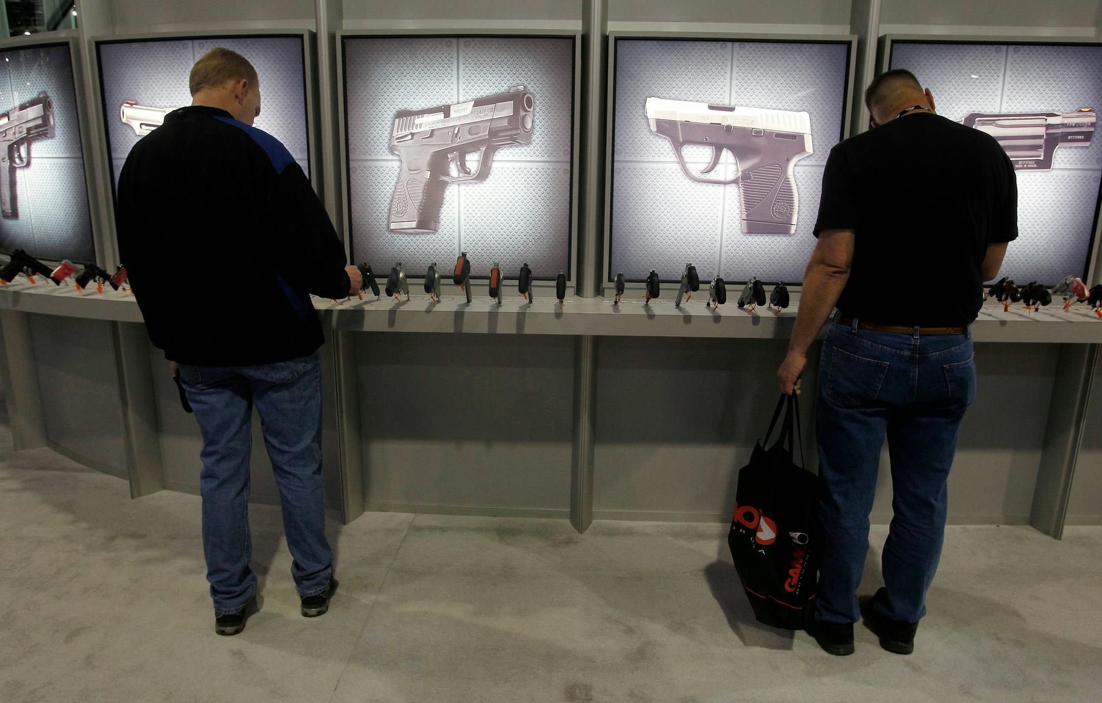 Patrons viewed handguns on display at a trade show in Las Vegas in 2011. Sales at gun shows still occur and as long as they are private sales — not by a federally licensed firearms dealer — no background check is required. But that's not really where the action is. As with most everything these days, online sales have taken off.