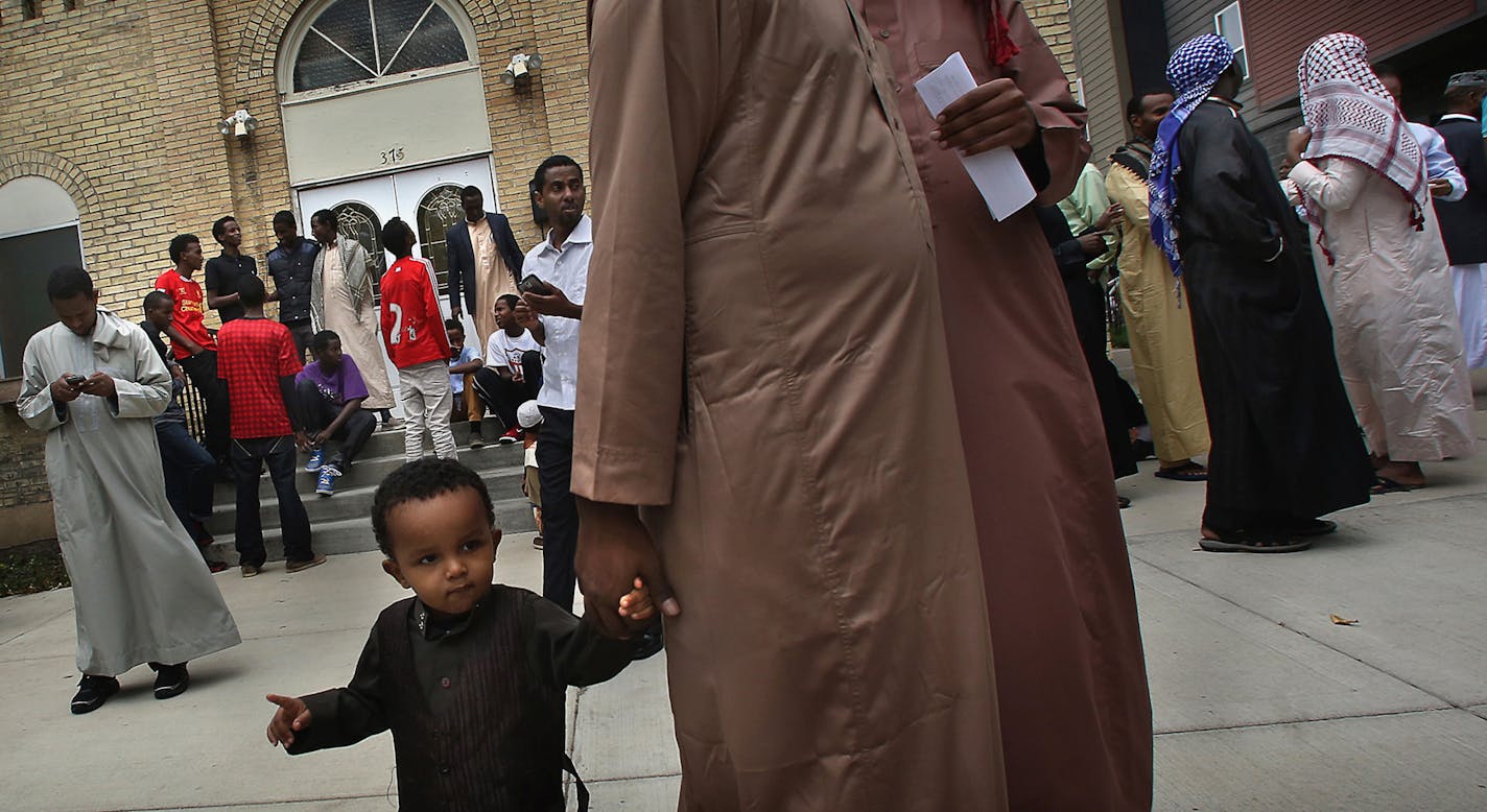 Abdullahi Hassan, 18 months, waited patiently while holding the hand of his father, Bashir Farah, after a Friday afternoon prayer service at the Islamic Center of St. Cloud. ] (JIM GEHRZ/STAR TRIBUNE) / October 11, 2013, St. Cloud, MN &#x201a;&#xc4;&#xec; BACKGROUND INFORMATION: After some heavy protest from neighbors and other residents, the Islamic Center of St. Cloud has withdrawn its application to build a mosque on the city&#x201a;&#xc4;&#xf4;s south side.