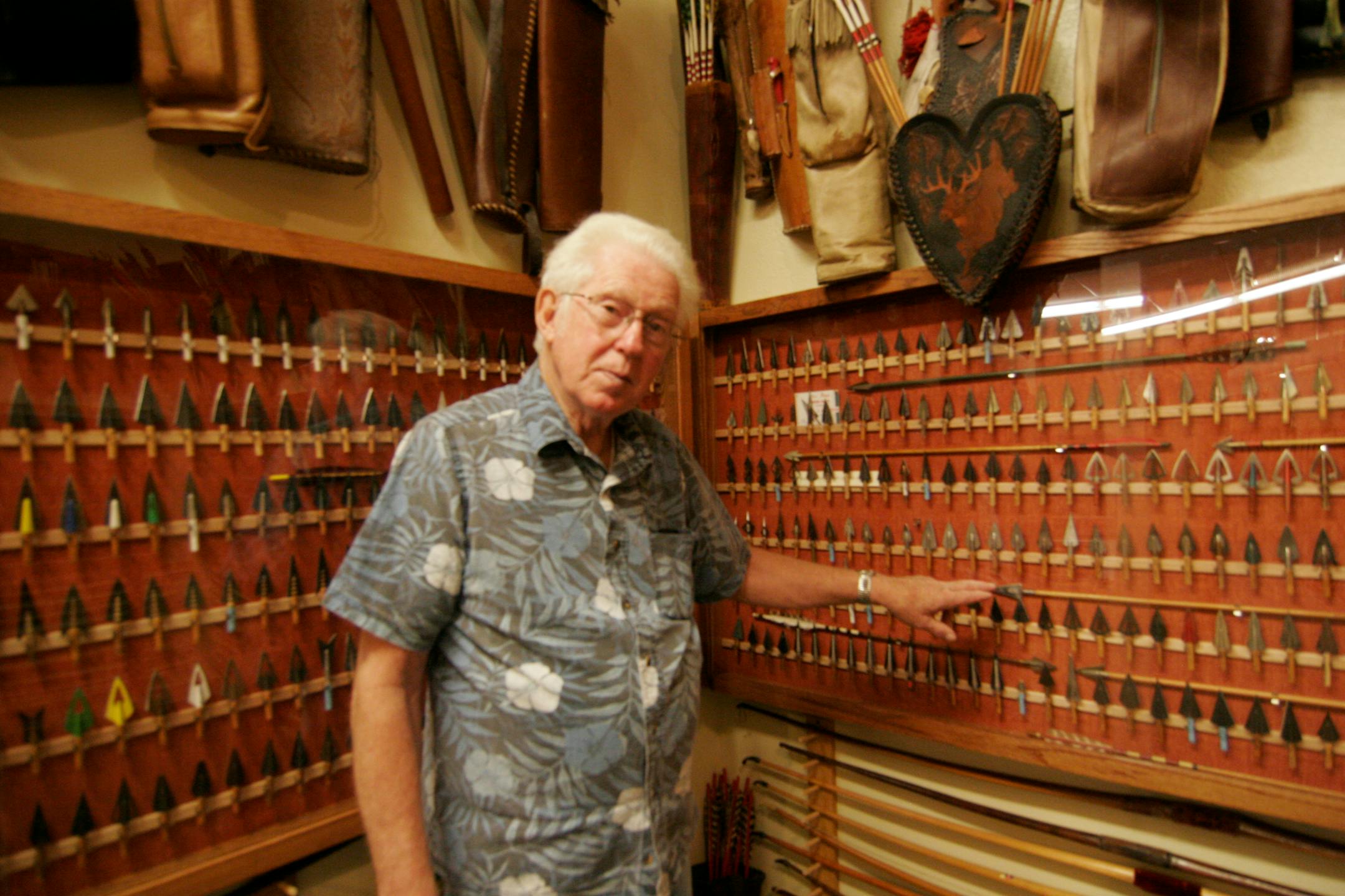 Glenn Hisey, executive secretary and director of the Pope and Young Club Museum in Chatfield, Minn., along with some of the extensive display of broadhead arrow tips at the museum. Star Tribune photo by Doug Smith