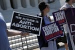 Anti-abortion protesters demonstrate outside the Supreme Court in Washington on Thursday. The Supreme Court unanimously rejected a bid to sharply curt
