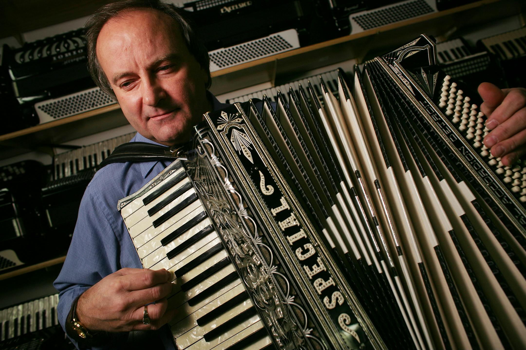 JERRY HOLT �jgholt@startribune.com2/19/2008 ---Ken Mahler played one of the many accordions in his store in St. Paul, the store has been in business since 1983.