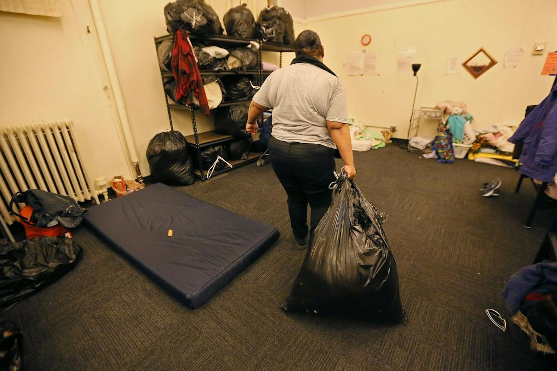 Mandisha Kelley packed her bedding into a plastic garbage bag to be stored away at the Simpson Housing Shelter, Friday, February 12, 2016 in Minneapolis, MN.