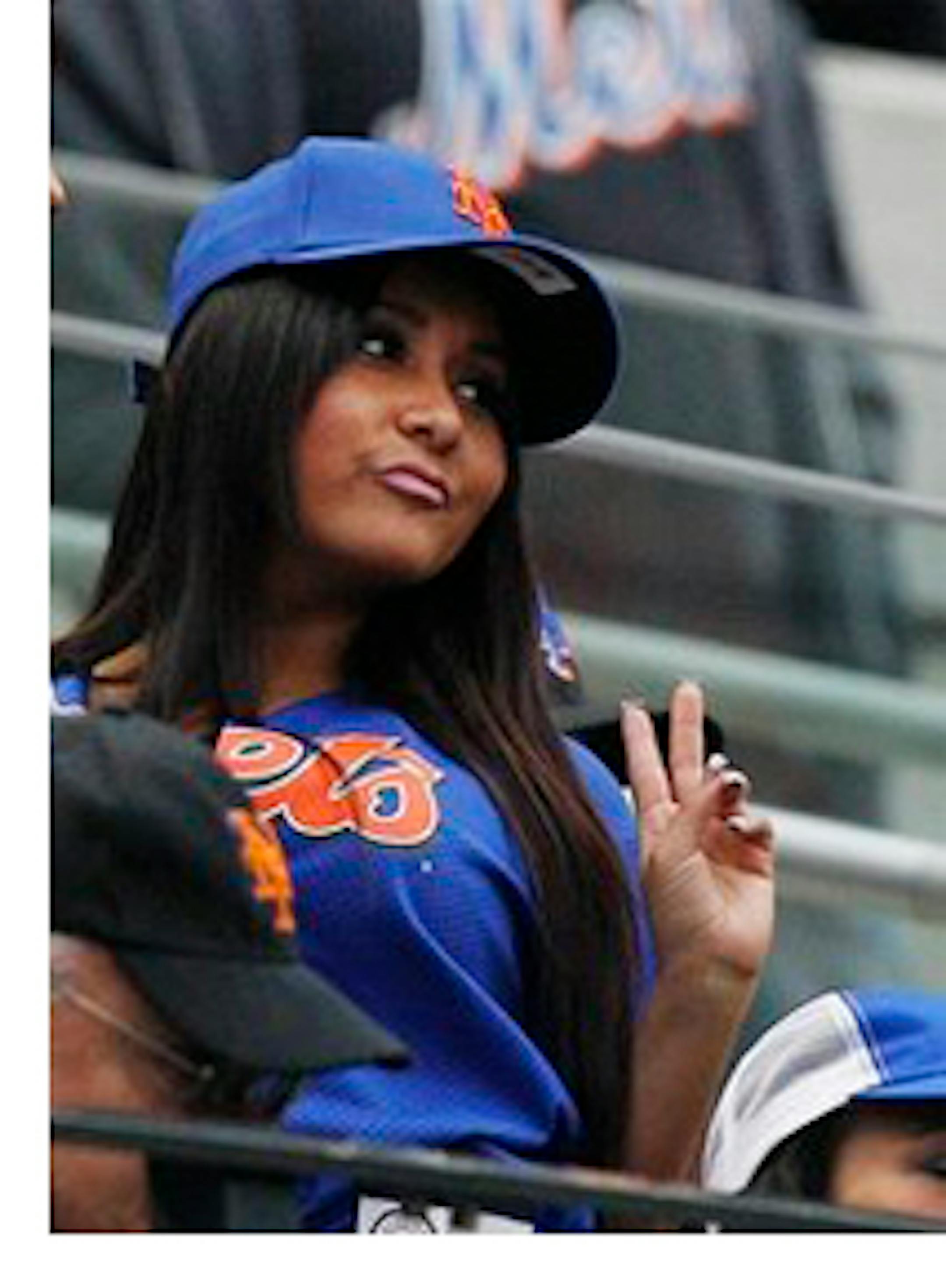 Nicole 'Snooki' Polizzi poses for a photograph by a fan during the fifth inning of a baseball game between the Washington Nationals and the New York Mets, Friday, April 8, 2011, at CitiField in New York. (AP Photo/Frank Franklin II)