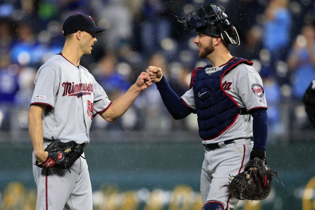 Minnesota Twins relief pitcher Taylor Rogers (55) and catcher Mitch Garver, right, celebrate following a baseball game against the Kansas City Royals 