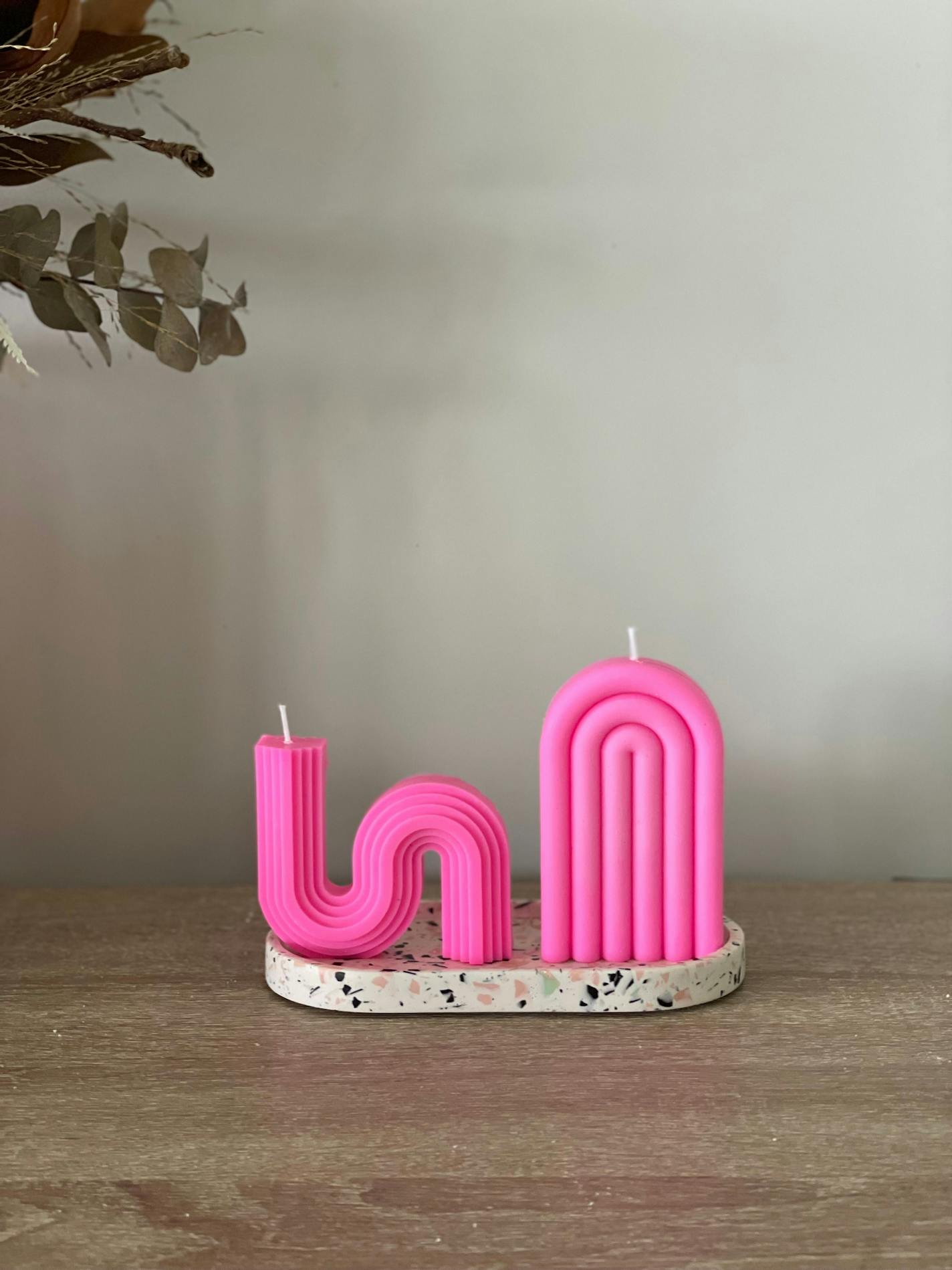 Adding pink accessories, such as these candles by Junebeginnings on Etsy, is a quick way to bring Barbiecore into your home. MUST CREDIT: Etsy/Junebeginnings