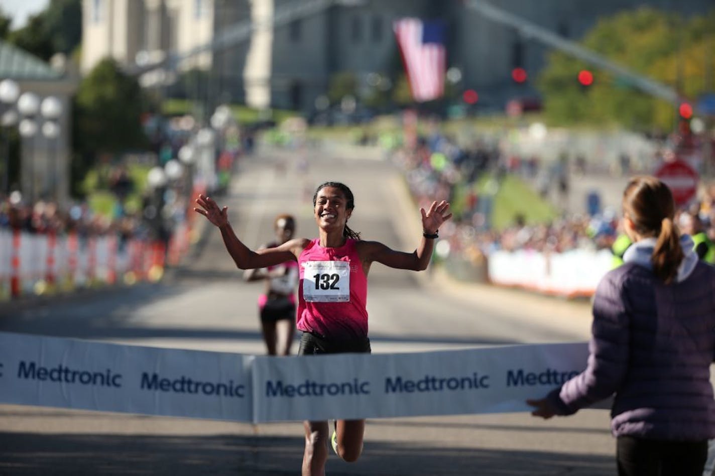 Serkalem Abraha of Ethiopia, the women's winner, crosses the finish line of the Twin Cities Marathon in St. Paul, Minn., on Sunday, Oct. 3, 2015.