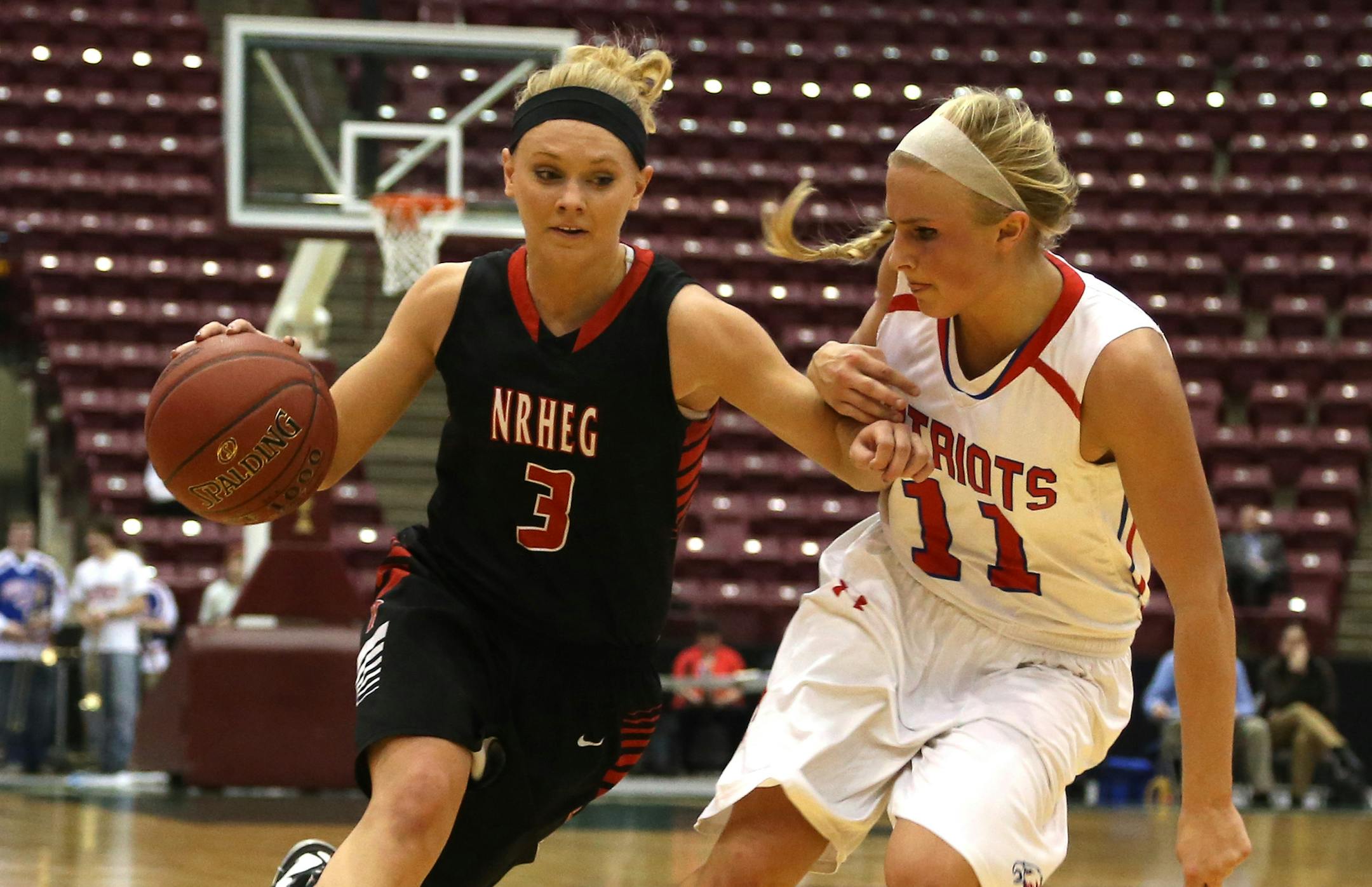 New Richland-HEG's Carlie Wagner drove passe Pequot Lakes Vanessa Lane defending during the second half ] (KYNDELL HARKNESS/STAR TRIBUNE) kyndell.harkness@startribune.com During the 2A quarterfinals at Mariucci Arena in Minneapolis Min, Wednesday March 19, 2014 New Rchland-HEG won over Pequot Lakes 100-68.