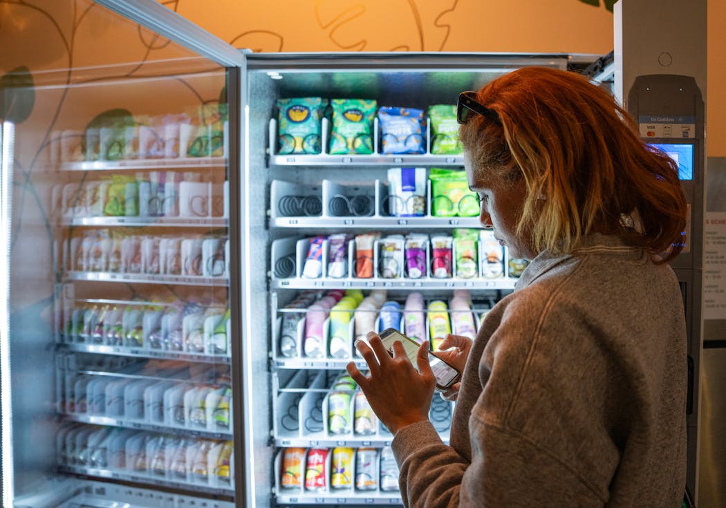 Tatiana Freeman, founder of Nosh Posh, filled a vending machine inside Wilderness Fitness and Co-working in Minneapolis.