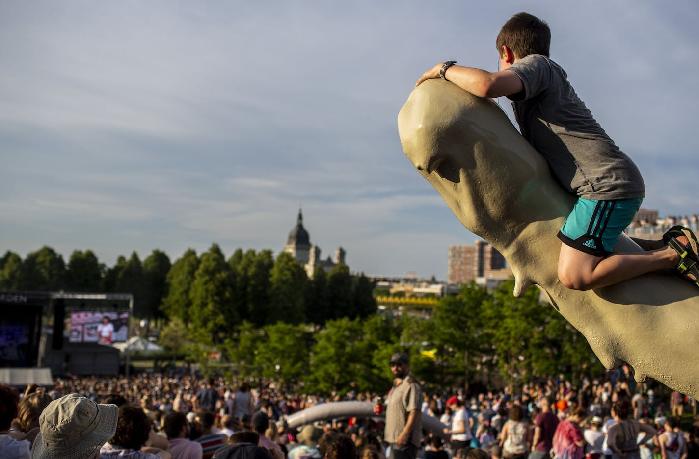 Zev Gilchrist, 9, climbs a statue to watch the stage. ] NICOLE NERI &#x2022; nicole.neri@startribune.com BACKGROUND INFORMATION: The annual Rock the Garden music festival at the Walker Art Center Saturday, June 29, 2019.