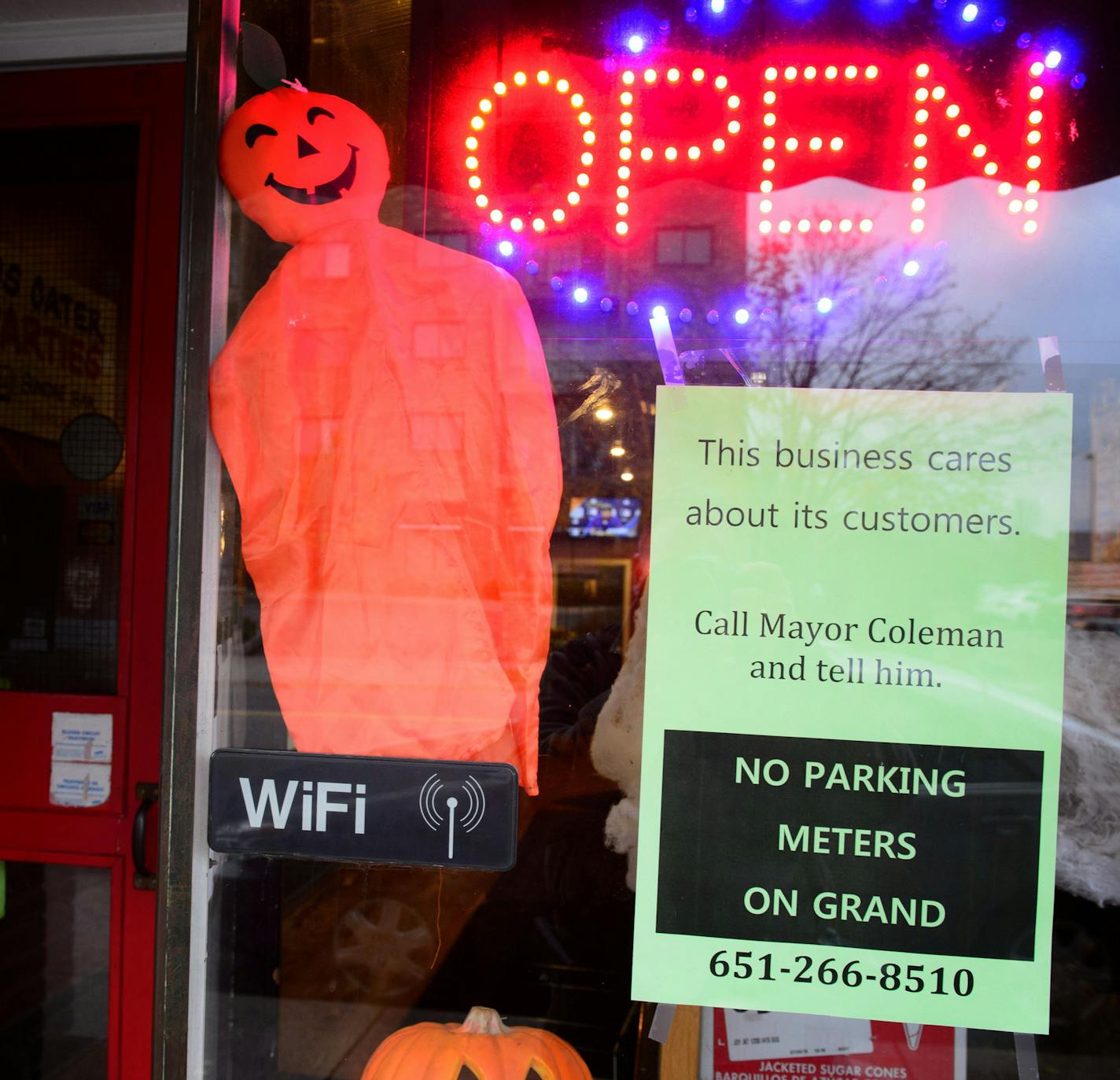 The sign in the front window of Grand Ole Creamery was opposed to parking meters on Grand Avenue, St. Paul. ] GLEN STUBBE * gstubbe@startribune.com Thursday October 29, 2015 Following report that the city of St. Paul may be dropping its proposal to install parking meters on Grand Avenue, in the face of widespread community opposition. Looking for a nice, overview shot of Grand Ave., especially something that captures cars and businesses.