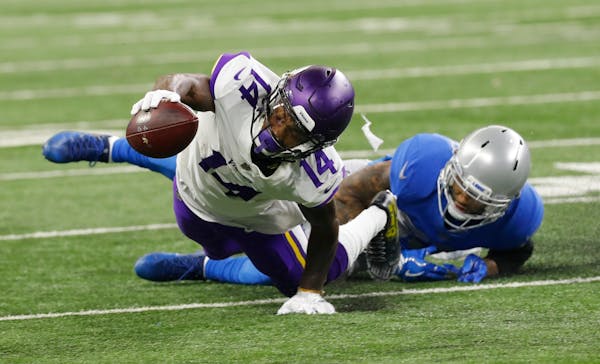 Vikings wide receiver Stefon Diggs stretches for yardage after being stopped by Lions cornerback Darius Slay in 2017.