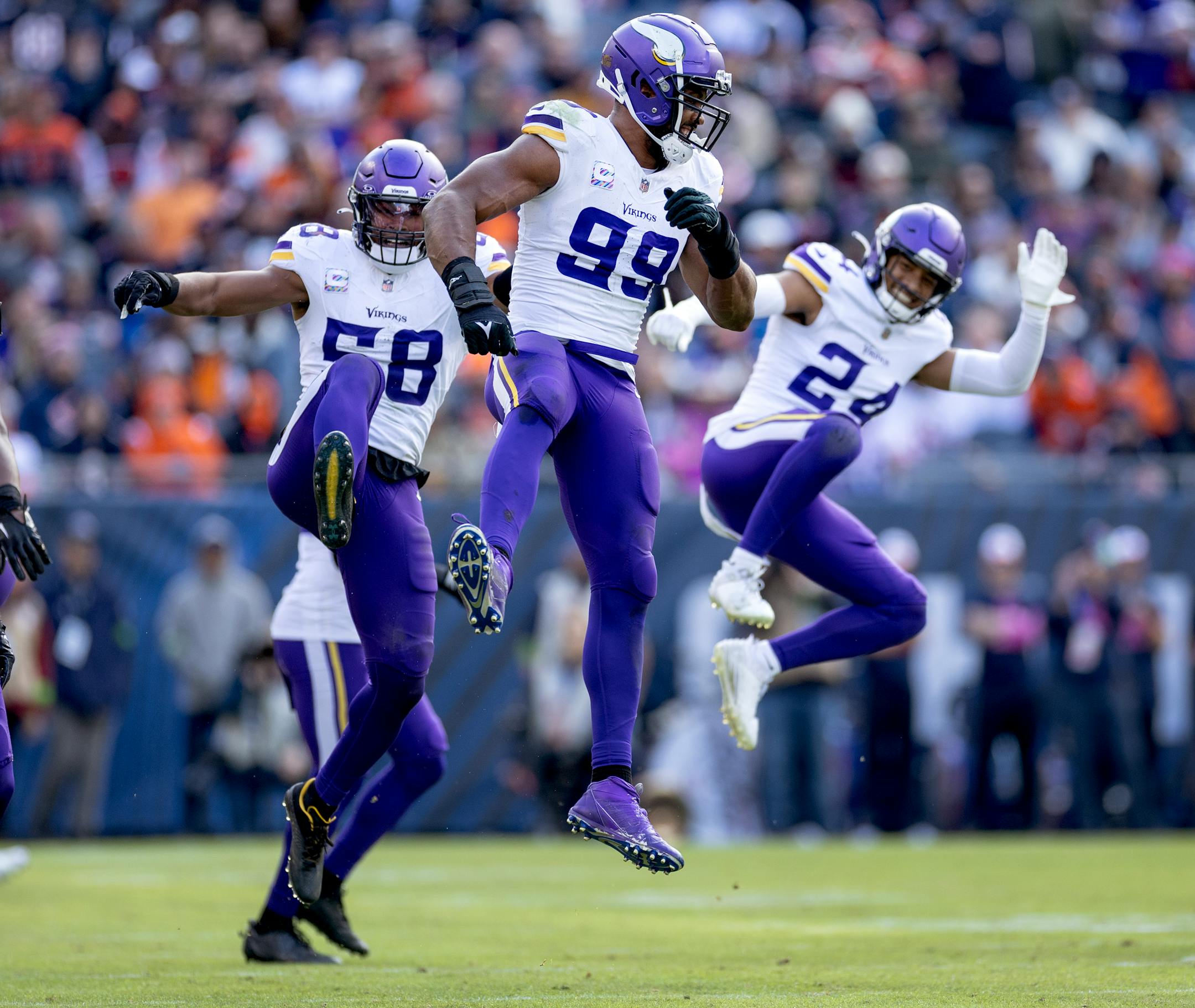 Minnesota Vikings Jordan Hicks (58), Danielle Hunter (99) and Camryn Bynum (24) celebrate a sack by Hunter in the third quarter.