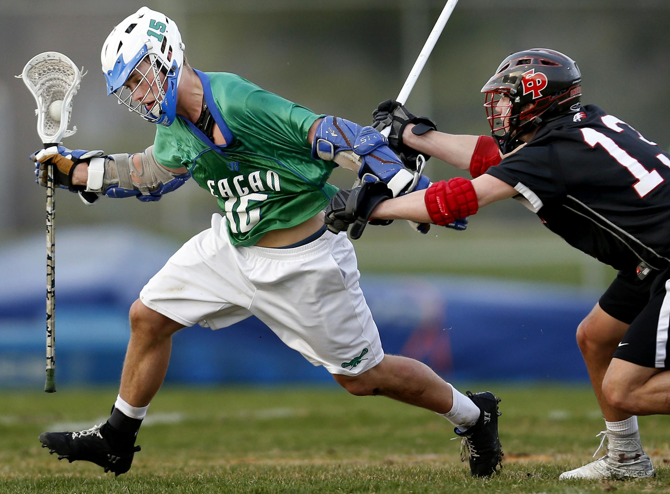 Cullen Willox of Eagan, left, and Arik Andreen of Eden Prairie battled in the first half of Monday’s boys’ lacrosse game. Eden Prairie held on for a 13-10 victory.